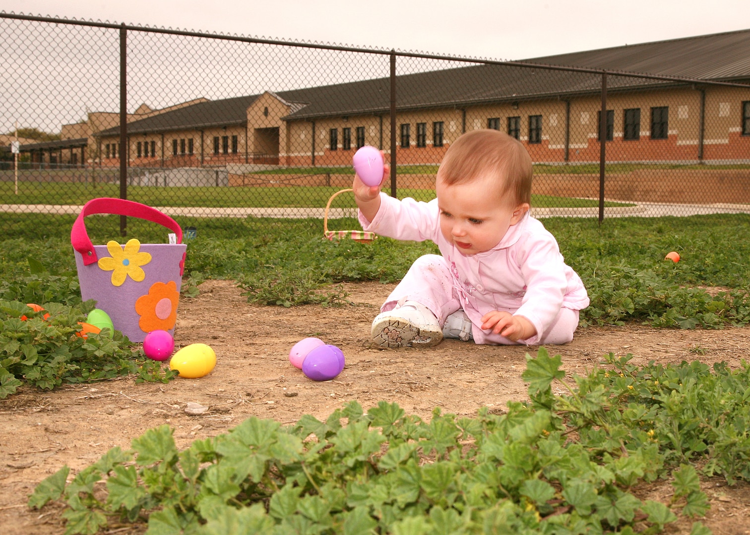 Zelany Conger picks up eggs during the Easter egg hunt at the Lackland Youth Center March 27. The FitFamily event included a healthy recipe contest and a free spaghetti luncheon. Zelany is the daughter of Staff Sgt. Travis Conger, 343rd Training Squadron. (U.S. Air Force photo/Robbin Cresswell)