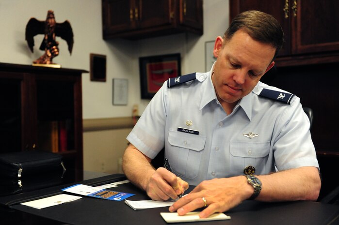 Col. Steve Garland, 99th Air Base Wing commander, signs  his Air Force Assistance Fund form, 29 March. The AFAF campaign is an annual effort to raise funds for charitable affiliates that provide support to Air Force families in need.
