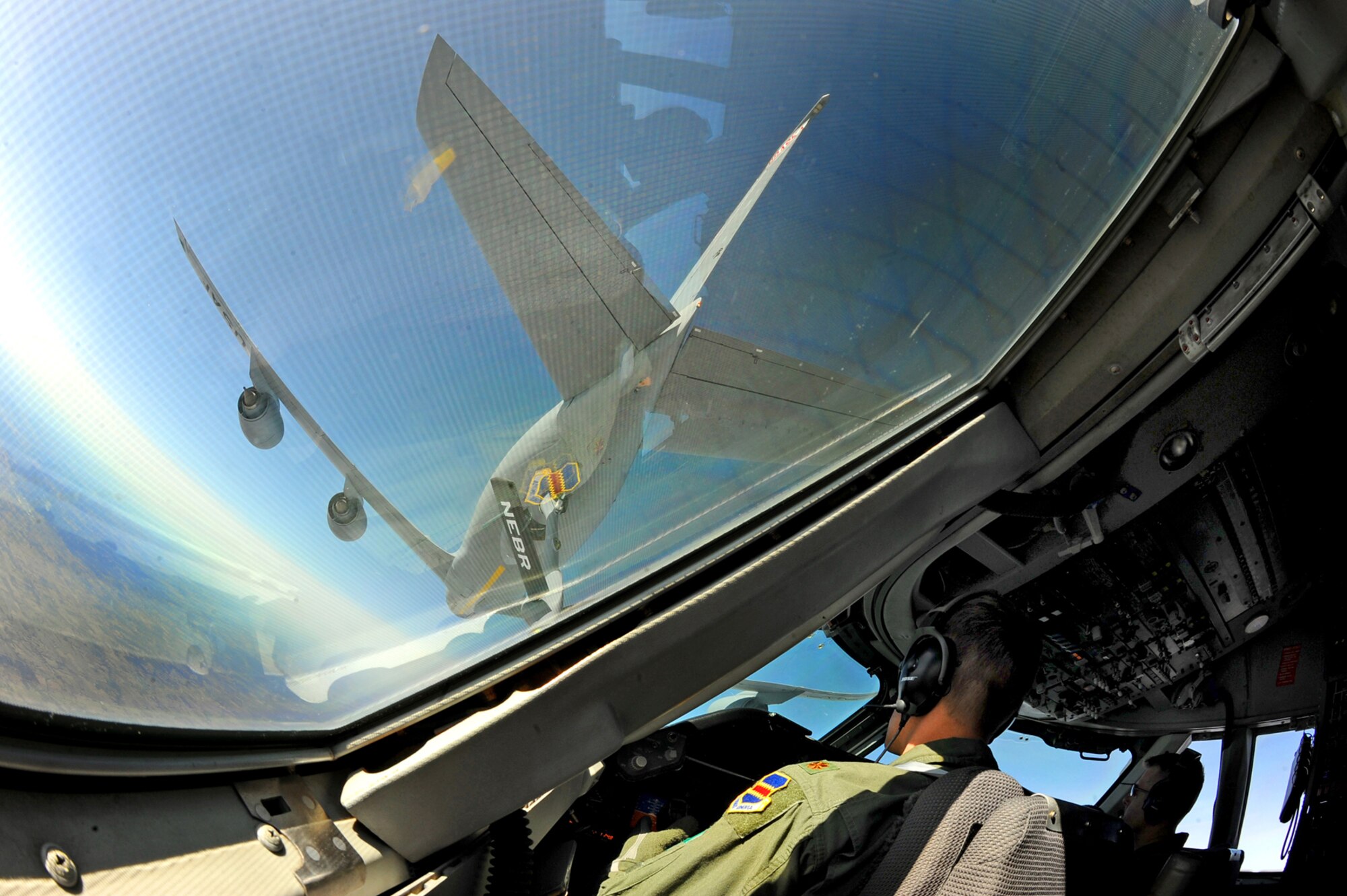 OFFUTT AIR FORCE BASE, Neb. -- Maj. James Podany, left, and Maj. Michael Bosiljevac, right, both pilots with the 1st Airborne Command and Control Squadron, move an E-4B into position March 26 to be refueled by a KC-135 aircraft from the 155th Air Refueling Wing, Lincoln, Neb., during a training exercise. The flight was filmed for a documentary that will be shown on the National Geographic channel later this year. Numerous videographers and producers spent the day with members of the 1st ACCS, getting hours of interviews and mission footage both on the ground and in flight. U.S. Air Force photo by Josh Plueger
