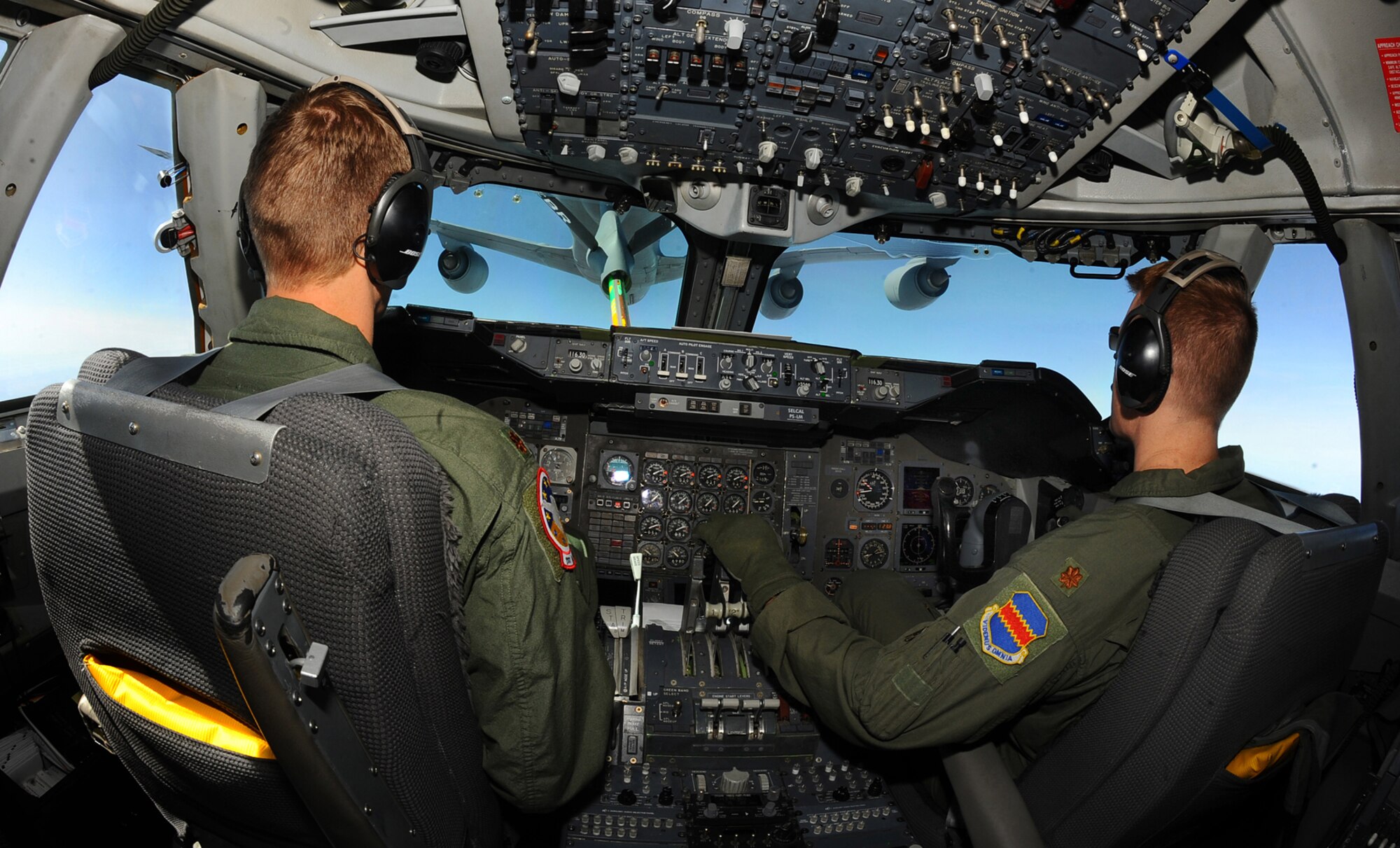 OFFUTT AIR FORCE BASE, Neb. -- Maj. James Podany, left, and Maj. Michael Bosiljevac, right, both pilots with the 1st Airborne Command and Control Squadron, move an E-4B into position March 26 to be refueled by a KC-135 aircraft from the 155th Air Refueling Wing, Lincoln, Neb., during a training exercise. The flight was filmed for a documentary that will be shown on the National Geographic channel later this year. Numerous videographers and producers spent the day with members of the 1st ACCS, getting hours of interviews and mission footage both on the ground and in flight. U.S. Air Force photo by Josh Plueger
