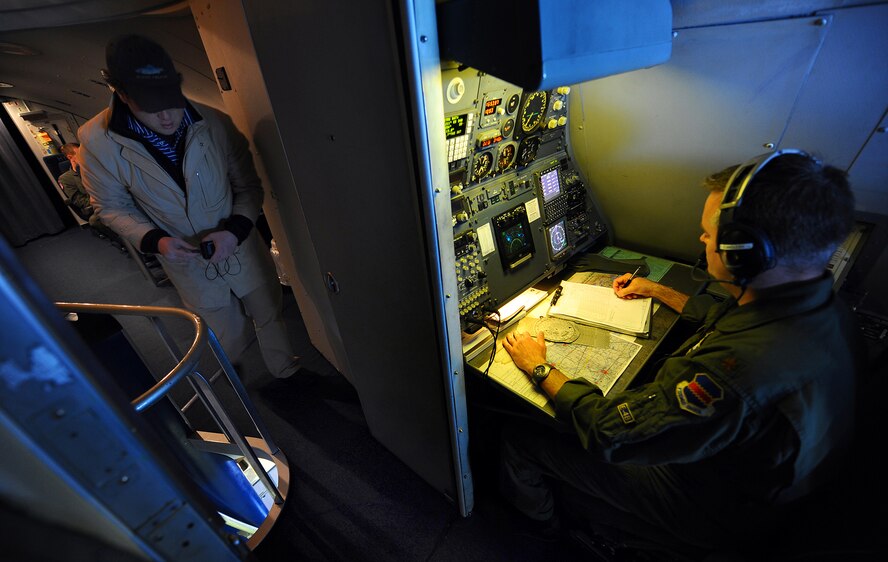 OFFUTT AIR FORCE BASE, Neb. -- Charles Fitzgerald, a senior supervising producer with Chicago based Towers Productions, walks into the cockpit of an E-4B with additional video gear as part of a documentary being filmed for the National Geographic channel, March 26. Numerous videographers and producers spent a full day with members from the 1st ACCS and National Airborne Command Center, getting hours of interviews and mission footage both on the ground and in flight. U.S. Air Force photo by Josh Plueger
