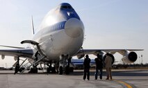 OFFUTT AIR FORCE BASE, Neb. -- A film crew from Towers Productions document members of the 1st Airborne Command and Control Squadron and the National Airborne Operatons Center's fire team, as they run into an E-4B aircraft here March 26 as part of a mock alert flight. The film crew is putting a documentary together for the National Geographic channel which will air later this year. Numerous videographers and producers spent the day with members from the two units, getting hours of interviews and mission footage both on the ground and in flight. U.S. Air Force photo by Josh Plueger
