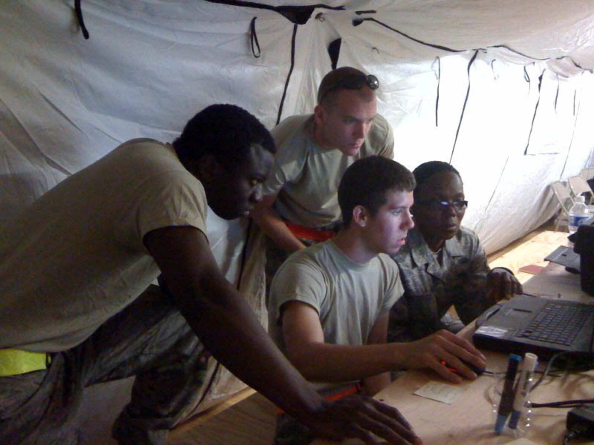 JOINT BASE MCGUIRE-DIX-LAKEHURST, N.J. - Reserve aerial port members from here review aircraft load schedules as part of thier duties in support of Operation Unified Response in Port Au Prince, Haiti. Nine Airman from the 35th and 88th Aerial Port Squadrons deployed mid-February to help the victims of the earthquake-stricken county. (U.S. Air Force photo)