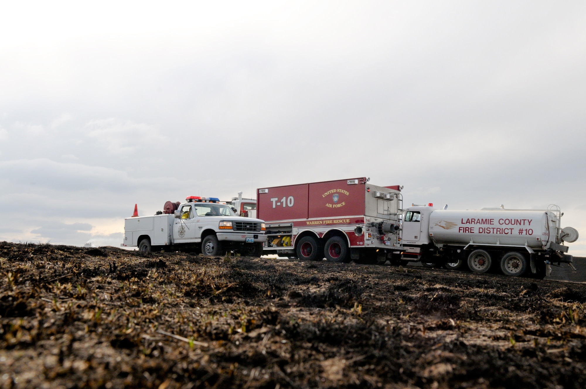 Members from the F.E. Warren Air Force Base Fire Department, Laramie County Fire Districts 1, 2, 8 and 10, as well as the Wyoming Air National Guard respond to the brushfire two miles southwest of the base March 31, 2010. (U.S. Air Force photo)