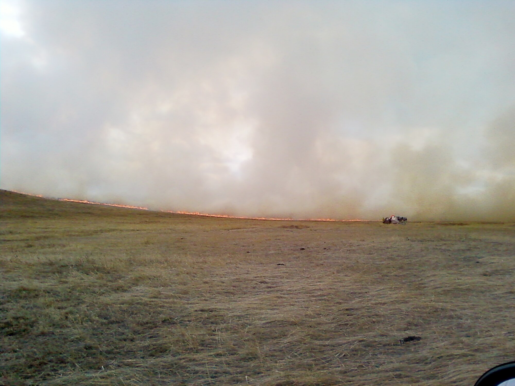 A brushfire blazes two miles southwest of F.E. Warren Air Force Base, Wyo., March 31, 2010. The Warren Fire Department, Laramie County Fire Districts 1,2,8 and 10, as well as the Wyoming Air National Guard responded to the incident. (U.S. Air Force photo)