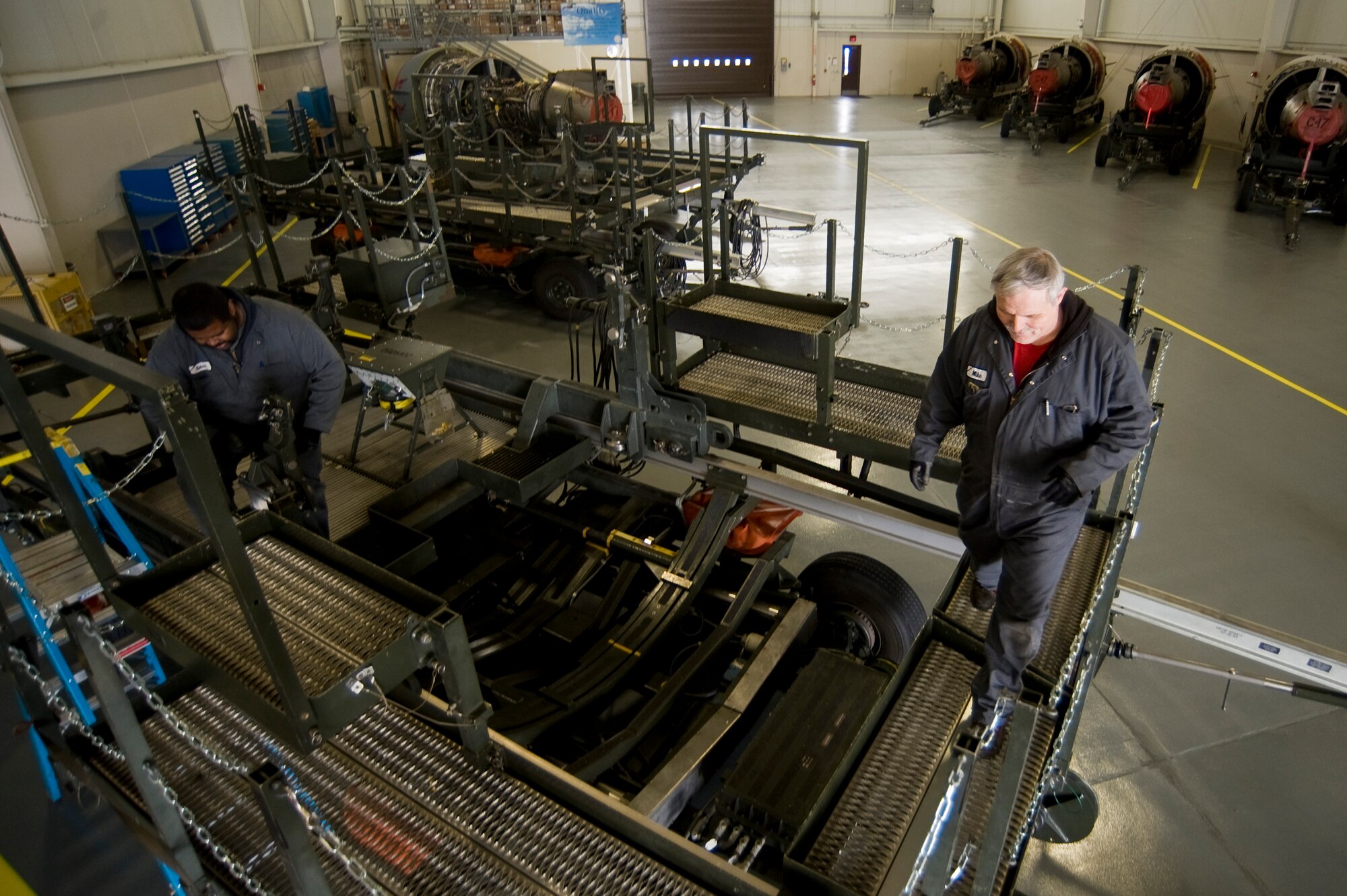 Boeing employees Robert Hopkins, left, and Michael Pittman perform a visual inspection of a C-17 Globemaster III engine lift stand at McChord Field's Module Replacement Center March 31. (U.S. Air Force Photo by Abner Guzman)