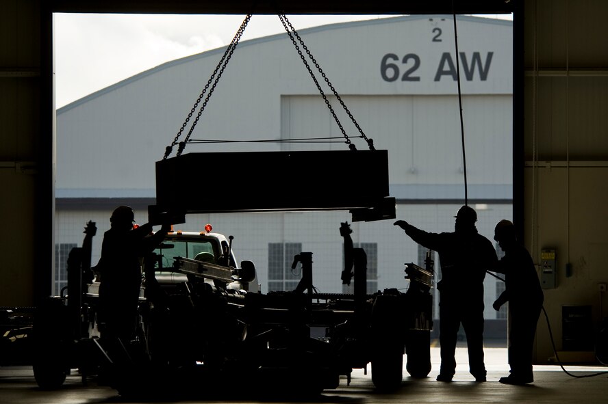 Boeing employees perform a two-year preventative maintenance inspection of a transport trailer at McChord Field's Module Replacement Center March 31. (U.S. Air Force Photo by Abner Guzman)