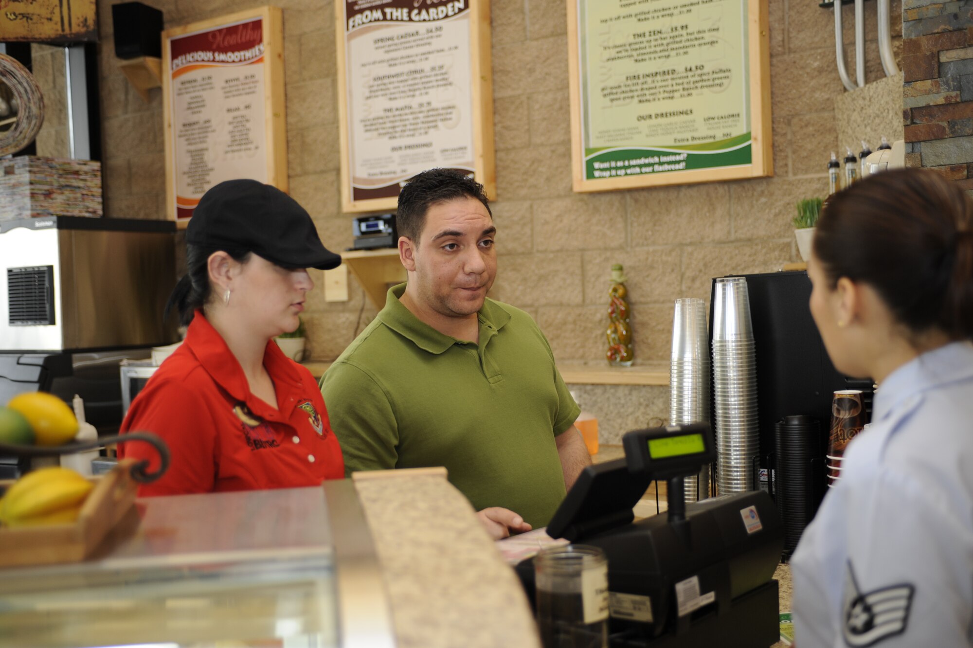 MOUNTAIN HOME AIR FORCE BASE, IDAHO – Pellegrino Caruso, Mountain Home AFB Fitness Center Bistro manager, and Krystal Torrez, Bistro barista, take the order for a low-calorie salad from one of their first customers March 29. The bistro provides Gunfighters healthier eating options through these low calorie salads. (U.S. Air Force photo by 1st Lt. Neil Samson)