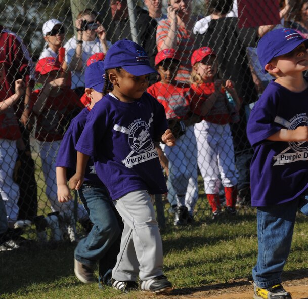 MOODY AIR FORCE BASE, Ga. -- Players from the “Purple Dragons Start Smart” tee ball team race onto the field during the beginning of spring sports ceremony here March 30. The Start Smart program allows children to start playing sports at an early age. (U.S. Air Force photo by Airman 1st Class Benjamin Wiseman/RELEASED)
