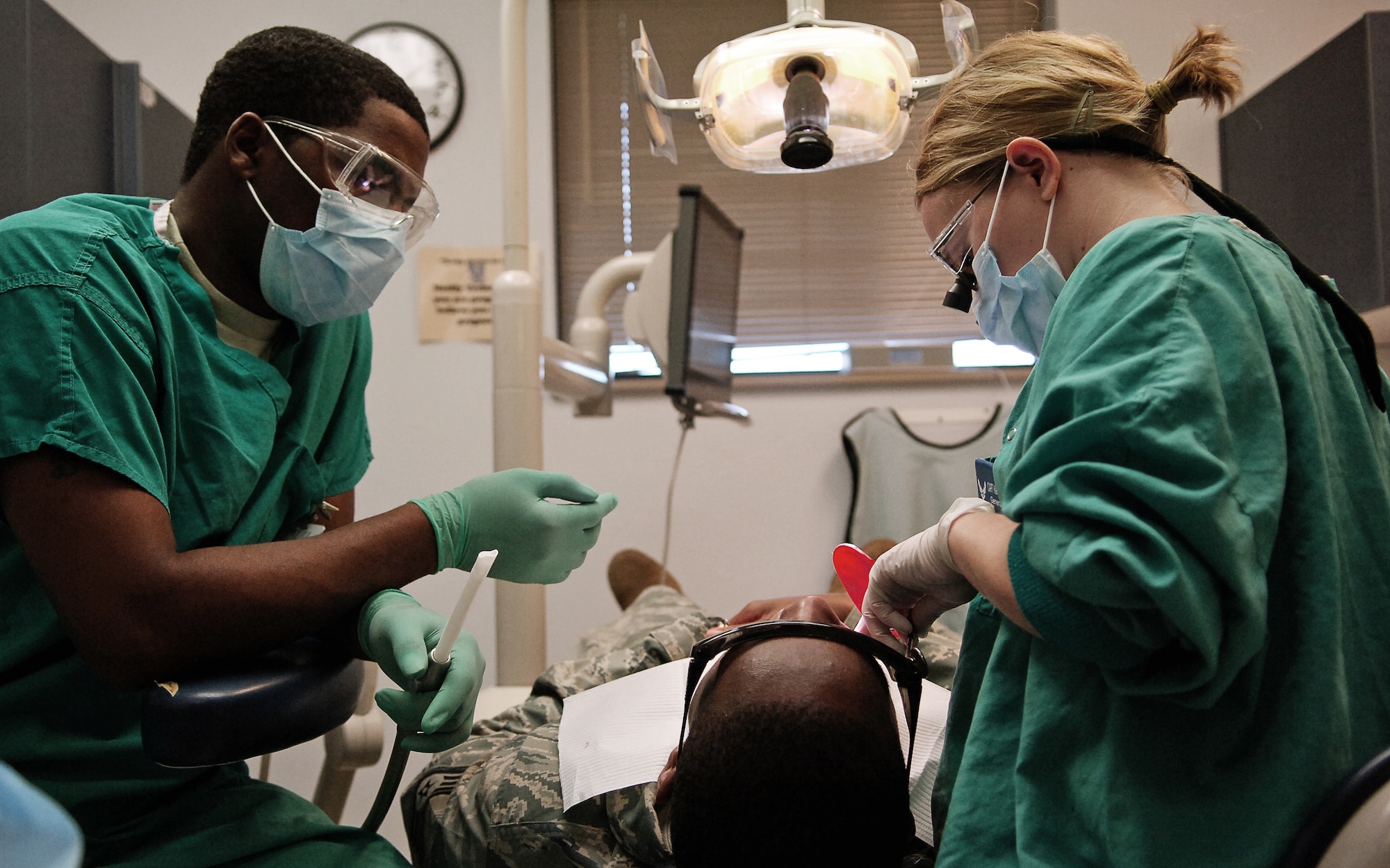 SCOTT AIR FORCE BASE, Ill. – Capt. Kelley Eltringham, 375th Dental Squadron dentist, applies sealant to a patient’s teeth with help from Airman 1st Class Johnakee Richmond, March 18, 2010. Along with typical dental services, the dental facilities on Scott mold and create custom orthodontics such as removable and permanent retainers for servicemembers. (U.S. Air Force photo/ Senior Airman Ryan Crane)