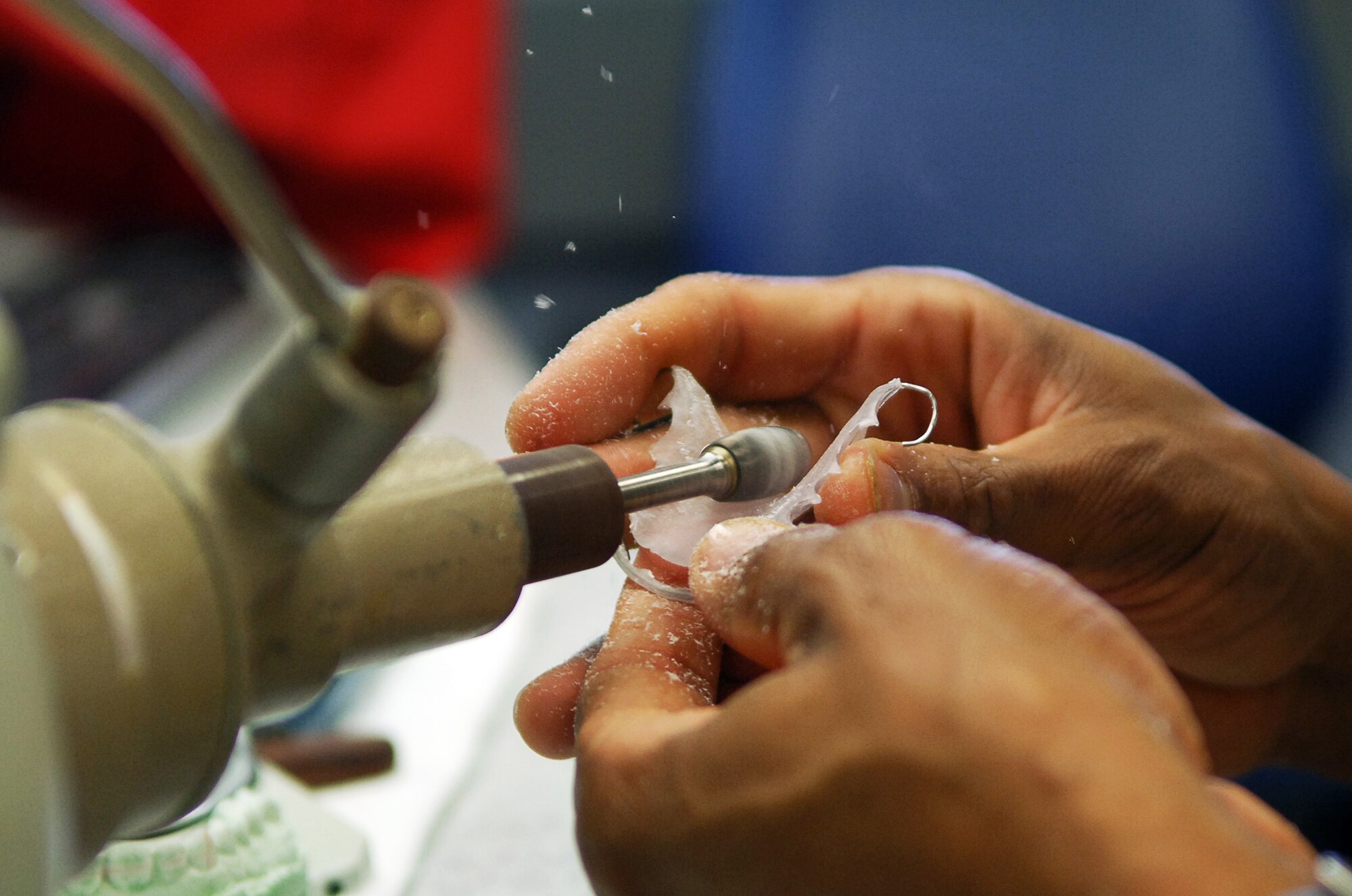 SCOTT AIR FORCE BASE, Ill. – Master Sgt. Keith Kinmon, 375th Dental Squadron laboratory technician, grinds down a removable retainer to create a custom fit for a patient, March 18, 2010. Along with typical dental services, the dental facilities on Scott mold and create custom orthodontics such as removable and permanent retainers for servicemembers. (U.S. Air Force photo/ Senior Airman Ryan Crane)