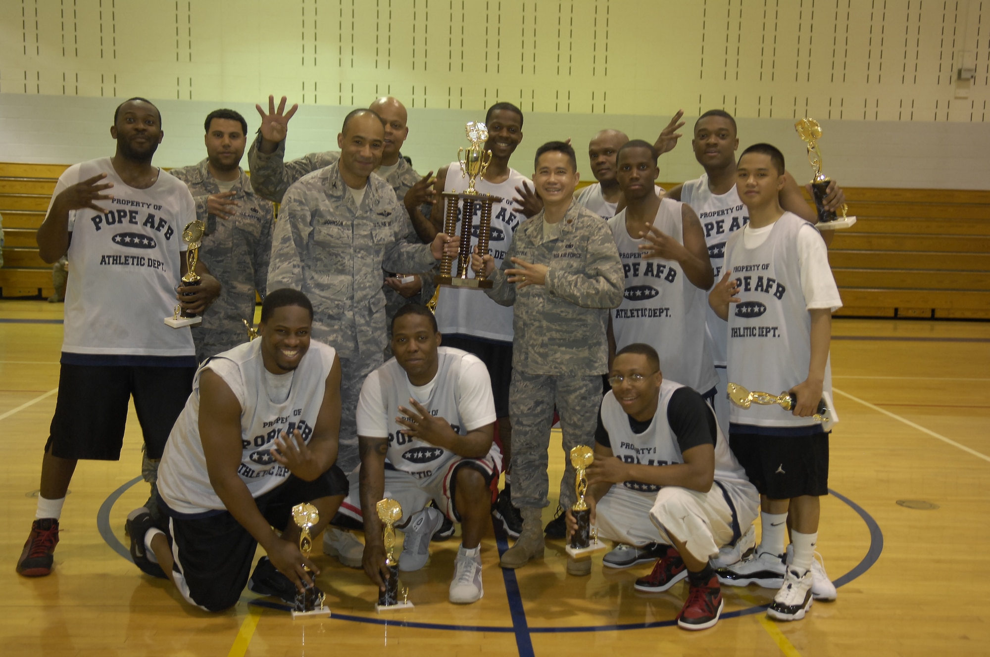 Col. James Johnson, 43rd Airlift Wing Commander, presents the Intramural Basketball Championship trophy to the 43rd Logistics Readiness Squadron Cobras March 24. The Cobras defeated the 43rd Force Support Squadron with a score of 41 to 33. (U.S. Air Force photo/ 2nd Lt. Cammie Quinn)