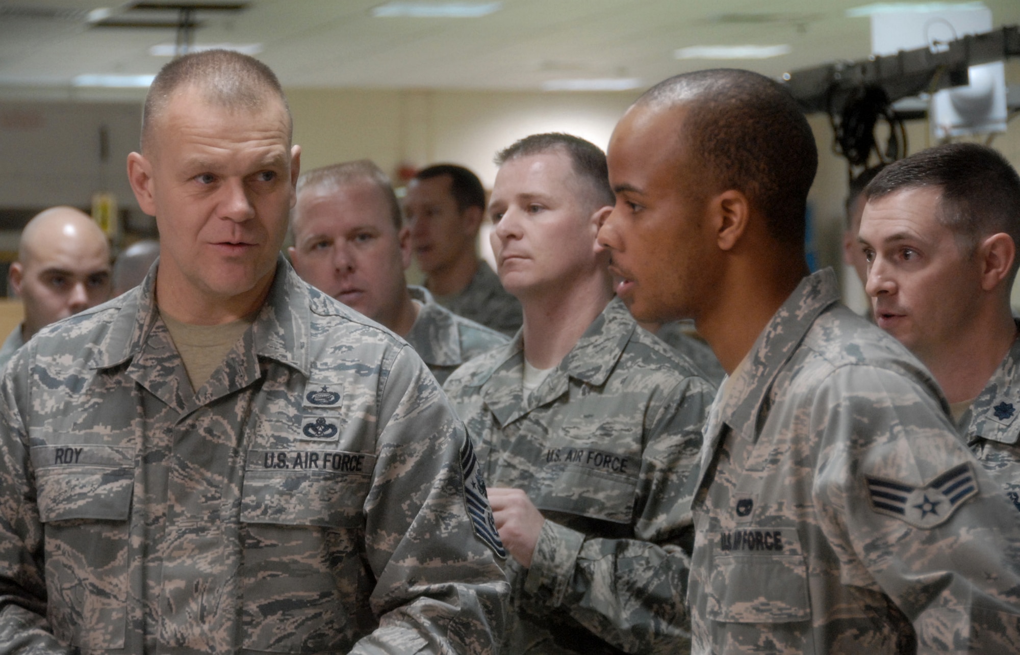 Chief Master Sgt. of the Air Force James A. Roy (left) asks Senior Airman Dussie Poole a question about electronic warfare pods March 18, 2010, at Eglin Air Force Base, Fla. Chief Roy's two-day visit to the base included tours of units within the various wings and speaking with junior enlisted and senior leadership on Air Force issues. Airman Poole is assigned to the 16th Electronic Warfare Squadron. (U.S. Air Force photo/Samuel King Jr.)