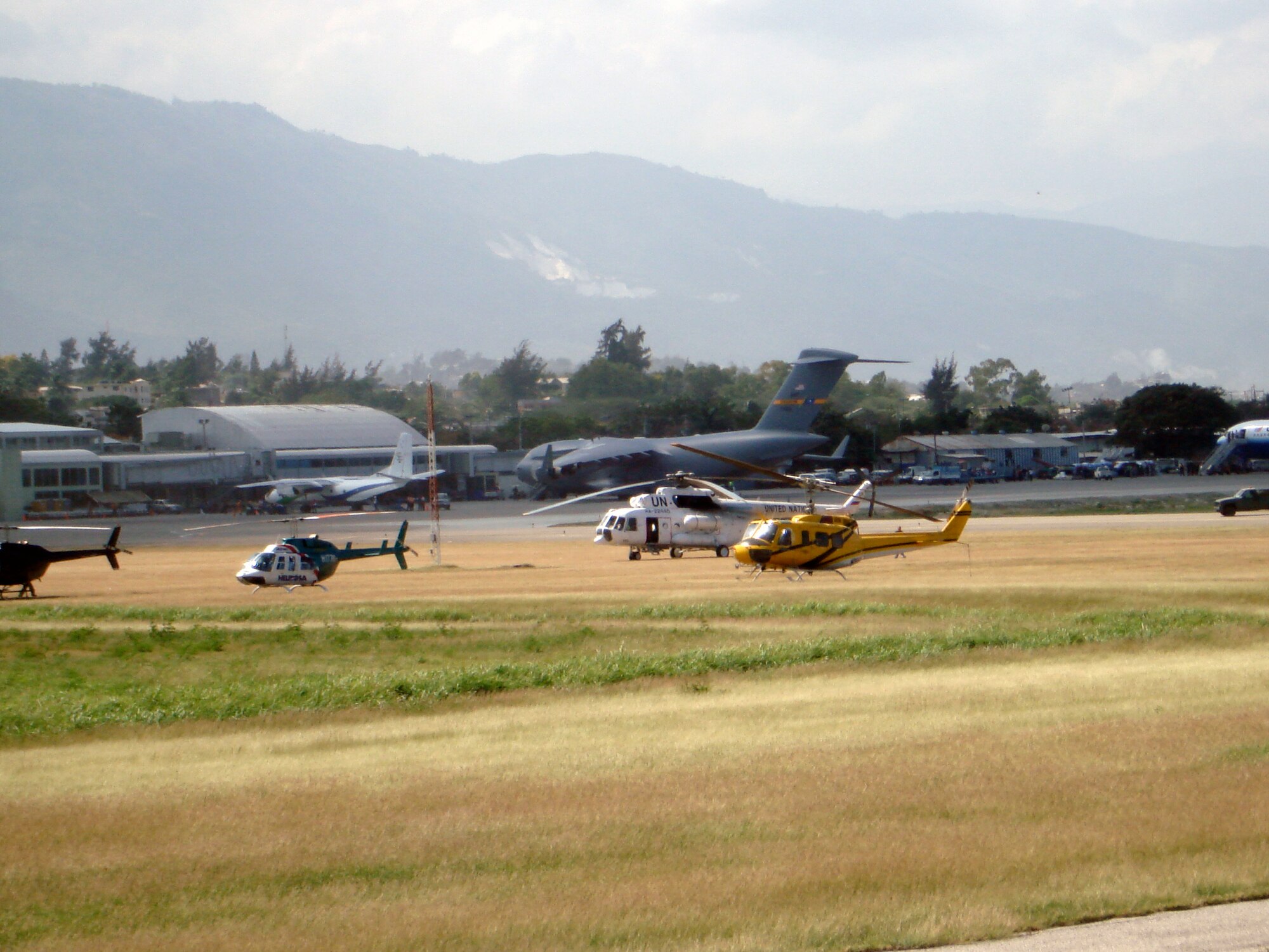 The parking ramp at the Port-Au-Prince, Haiti airport is filled to capacity with every type of transport aircraft from small piston-powered civilian airplanes to C-17s, Japanese C-130s, large commercial air carriers, and United Nations helicopters.

U.S.Air Force Photo by Capt. Greg Le Crone