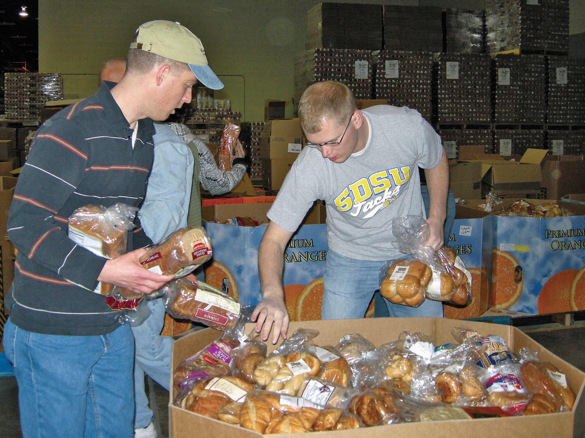 Staff Sgt. Christopher Callan, Kirtland Chapel, and 2nd Lt. Justin Wolthuizen, 377th Medical Operations Squadron, load a box of bread for shipping. Kirtland members get together the fourth Saturday of every month and volunteer at the Roadrunner Food Bank, preparing food shipments and stocking shelves.

U.S. Air Force Photo by Marie Vanover                     
