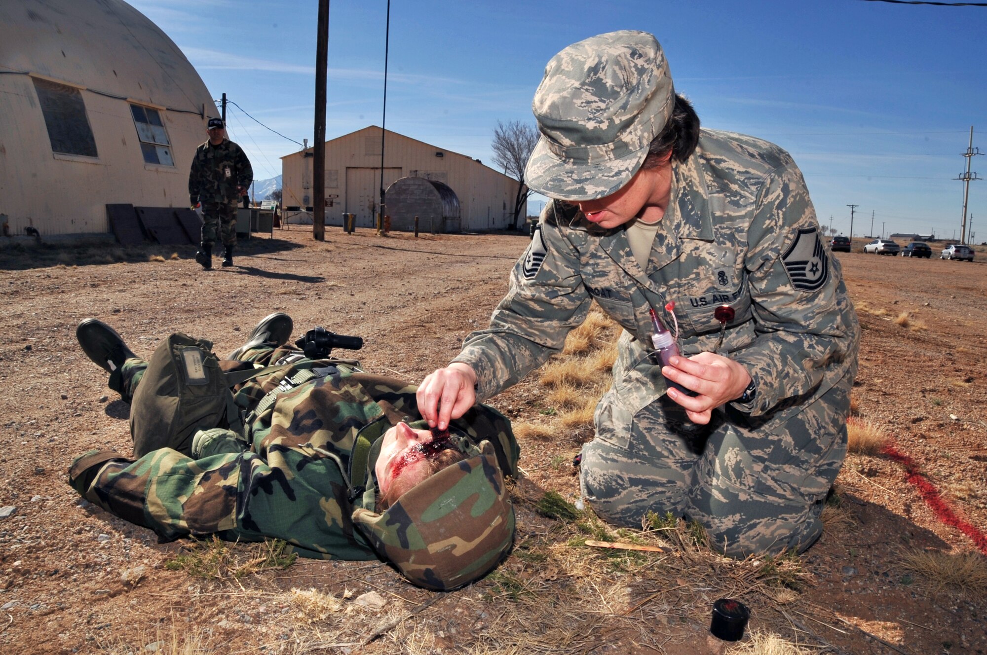 Master Sgt. Sheri DeGroat, 377th Medical Group, adds finishing touches on injuries to 1st Lt. Lyrica Phelps, Air Force Research Laboratory, who played a wounded Airman during an exercise.

U.S. Air Force Photo by Elizabeth Martinez