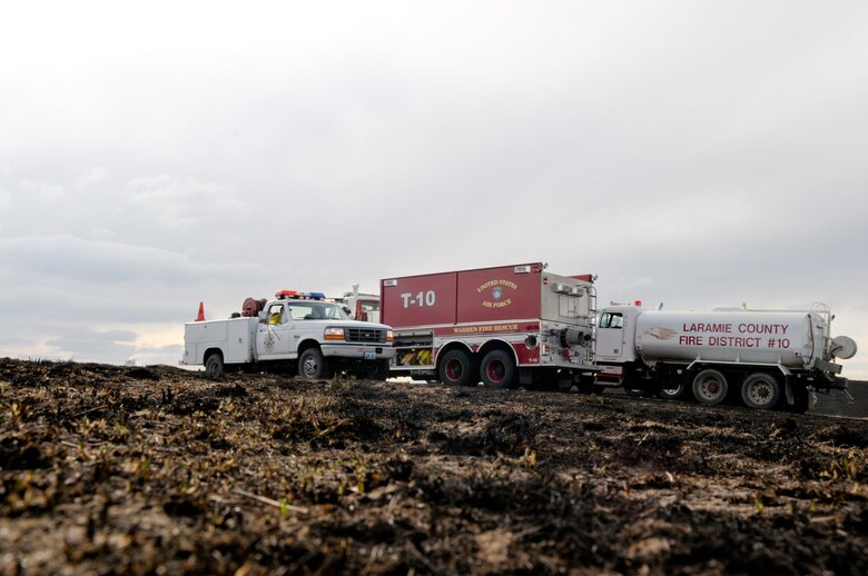 The Warren Fire Department, Laramie County Fire Districts 1,2,8 and 10, as well as the Wyoming Air National Guard respond to the brushfire two miles southwest of the base March 31.