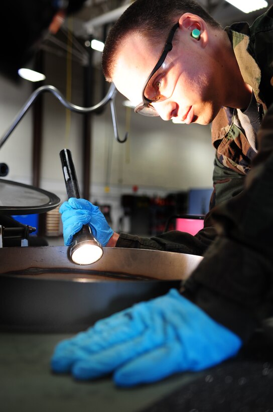 ELLSWORTH AIR FORCE BASE, S.D. -- Senior Airmen David Carter, 28th Maintenance Squadron aerospace ground equipment journeyman, inspects a reclaimed JP-8 fuel tank, March 31.  Airman Carter installed a new grounding cable reel on the fuel tank to prevent static electricity discharges. (U.S. Air Force photo/Airman 1st Class Anthony Sanchelli)