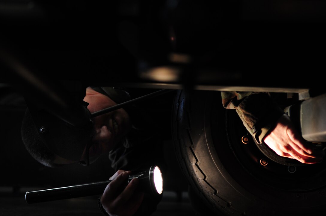ELLSWORTH AIR FORCE BASE, S.D. -- Senior Airmen David Carter, 28th Maintenance Squadron aerospace ground equipment journeyman, inspects underneath a reclaimed JP-8 fuel tank, March 31.  Airman Carter inspected every area of the fuel tank making sure everything works properly. (U.S. Air Force photo/Airman 1st Class Anthony Sanchelli)