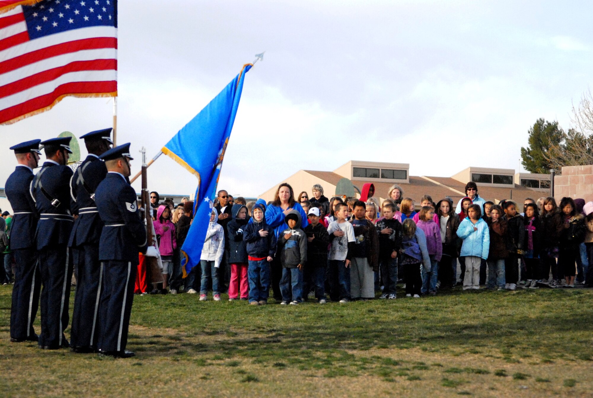 Branch Elementary School 4th graders recite the ?Pledge of Allegiance?, Blue Eagles Honor Guard members, left to right, Air Force Staff Sgts. Josh VanDerbeck, 95th Force Support Squadron, Angel Sanchez, 412th Operations Group, Tech. Sgts. Mike Anderson, 95th Force Support Squadron and Herald Padua, 412th Flight Test Squadron, present the Colors March 31. (Air Force photo/Stephen Robinson)