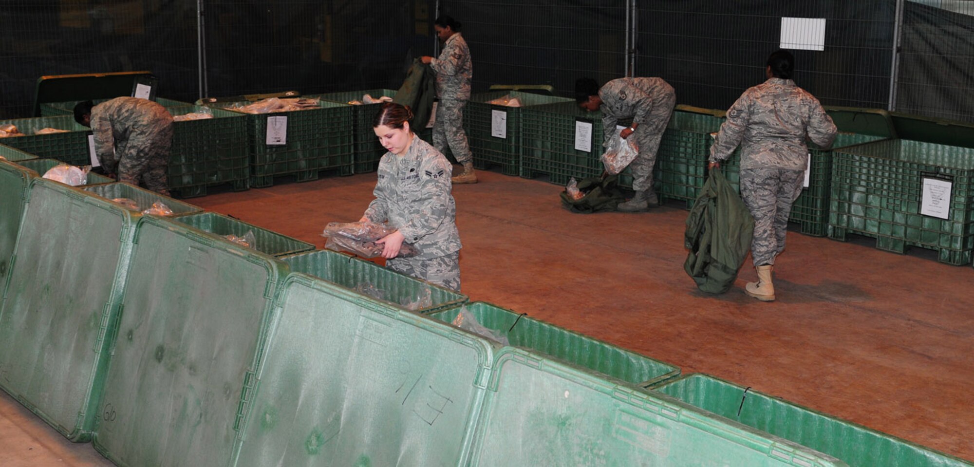 Reserve members from the 459th Logistics Readiness Flight, Andrews Air Force Base, Washington D.C., break down A and C mobility bags used during a recent Phase 1 exercise. Twenty-three reservists were at RAF Mildenhall March 13 through 28 for their annual training. They helped out in different sections of the 100th Logistics Readiness Squadron, including the mobility warehouse, where they helped verify stock and returned items to the storage bins. (U.S. Air Force photo/Karen Abeyasekere) 