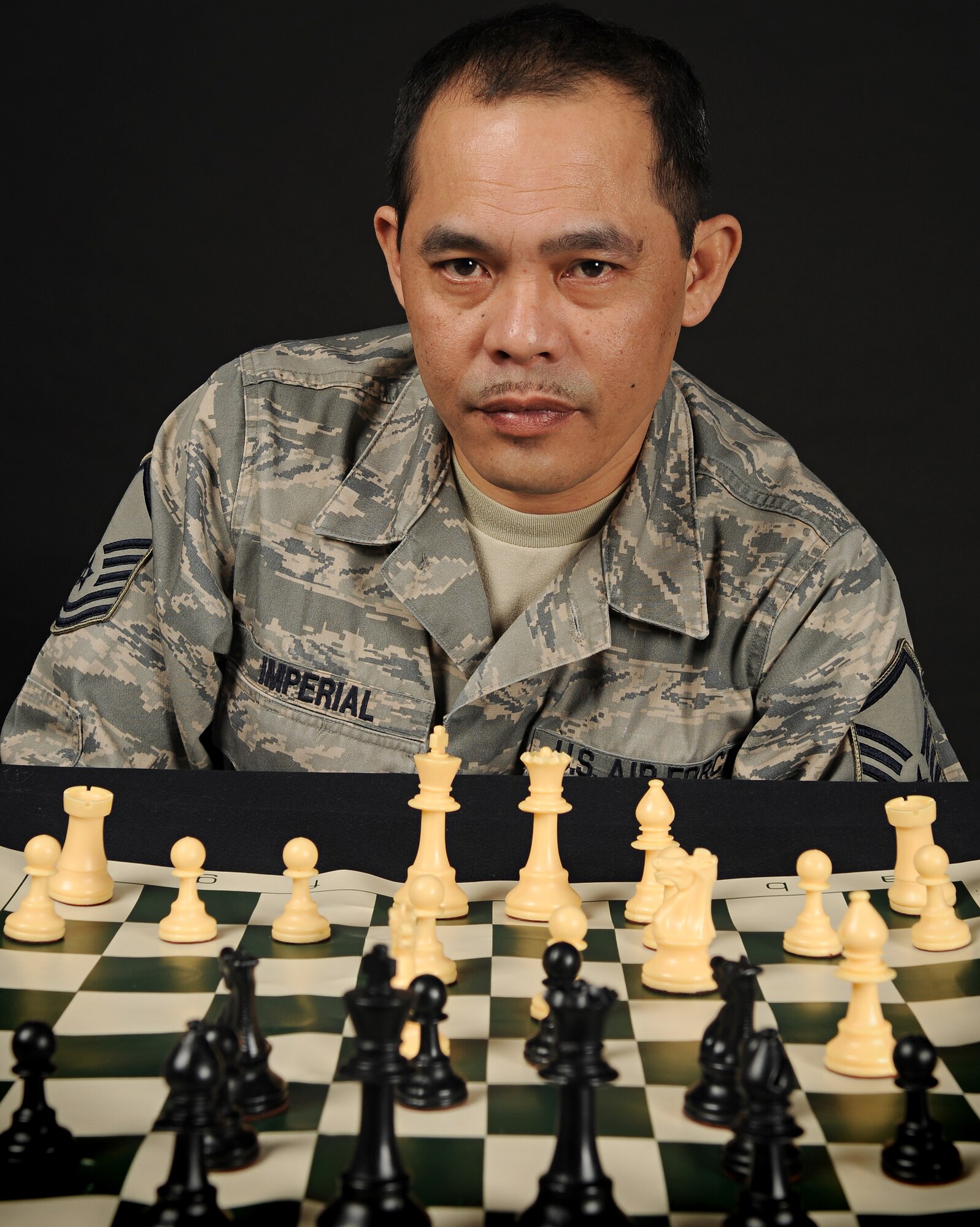 SPANGDAHLEM AIR BASE, Germany – Master Sgt. George Imperial, 52nd Logistics Readiness Squadron, sits behind his chess set. Sergeant Imperial, who has been playing chess since he was 6 years old, won a base-wide chess tournament March 28. (U.S. Air Force photo/Senior Airman Benjamin Wilson)