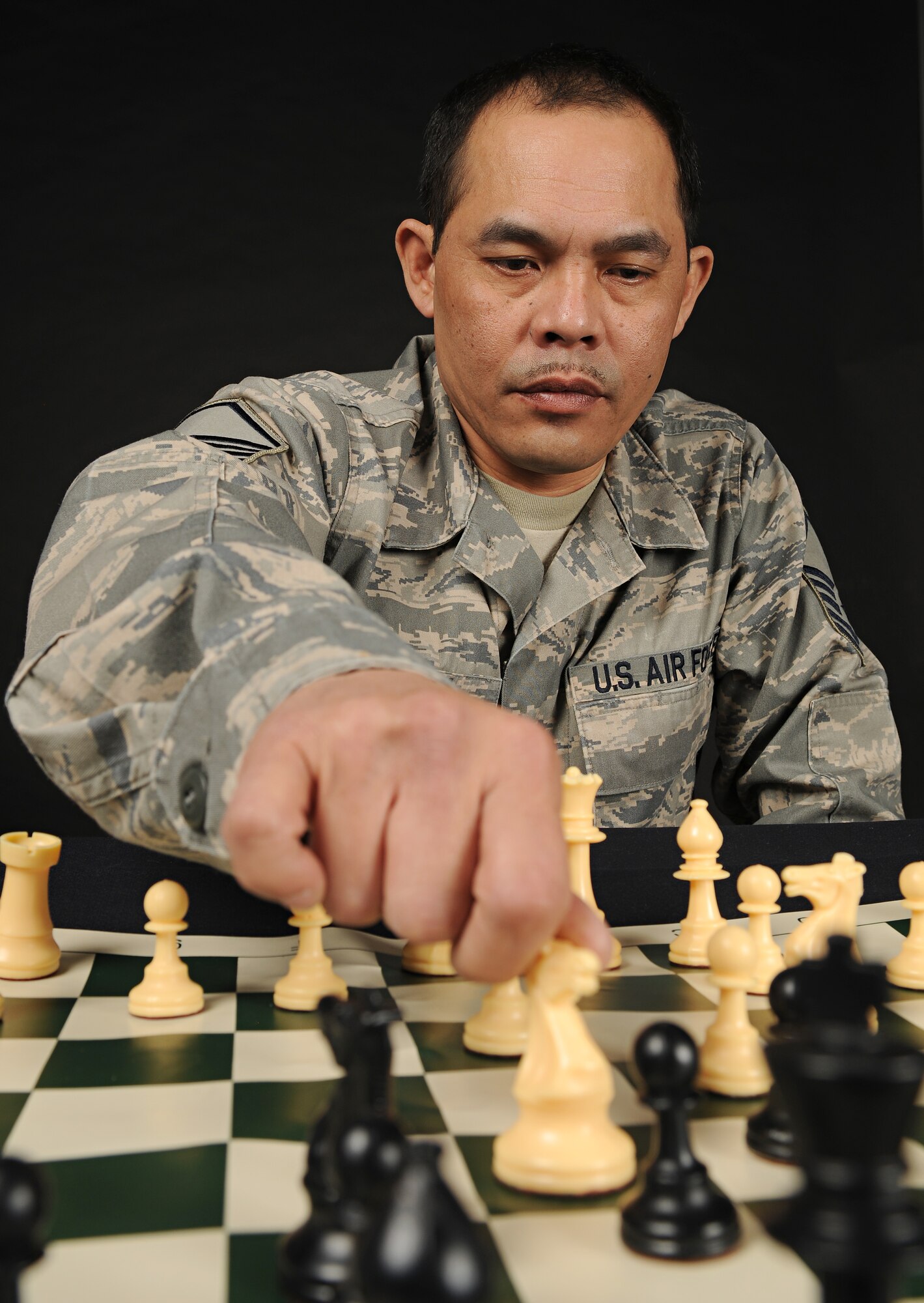 SPANGDAHLEM AIR BASE, Germany – Master Sgt. George Imperial, 52nd Logistics Readiness Squadron, repositions a knight on a chess board. Sergeant Imperial won first place in a wing-wide chess tournament March 28. The first-place prize was a chess table and chair set provided by a local vendor. (U.S. Air Force photo/Senior Airman Benjamin Wilson)