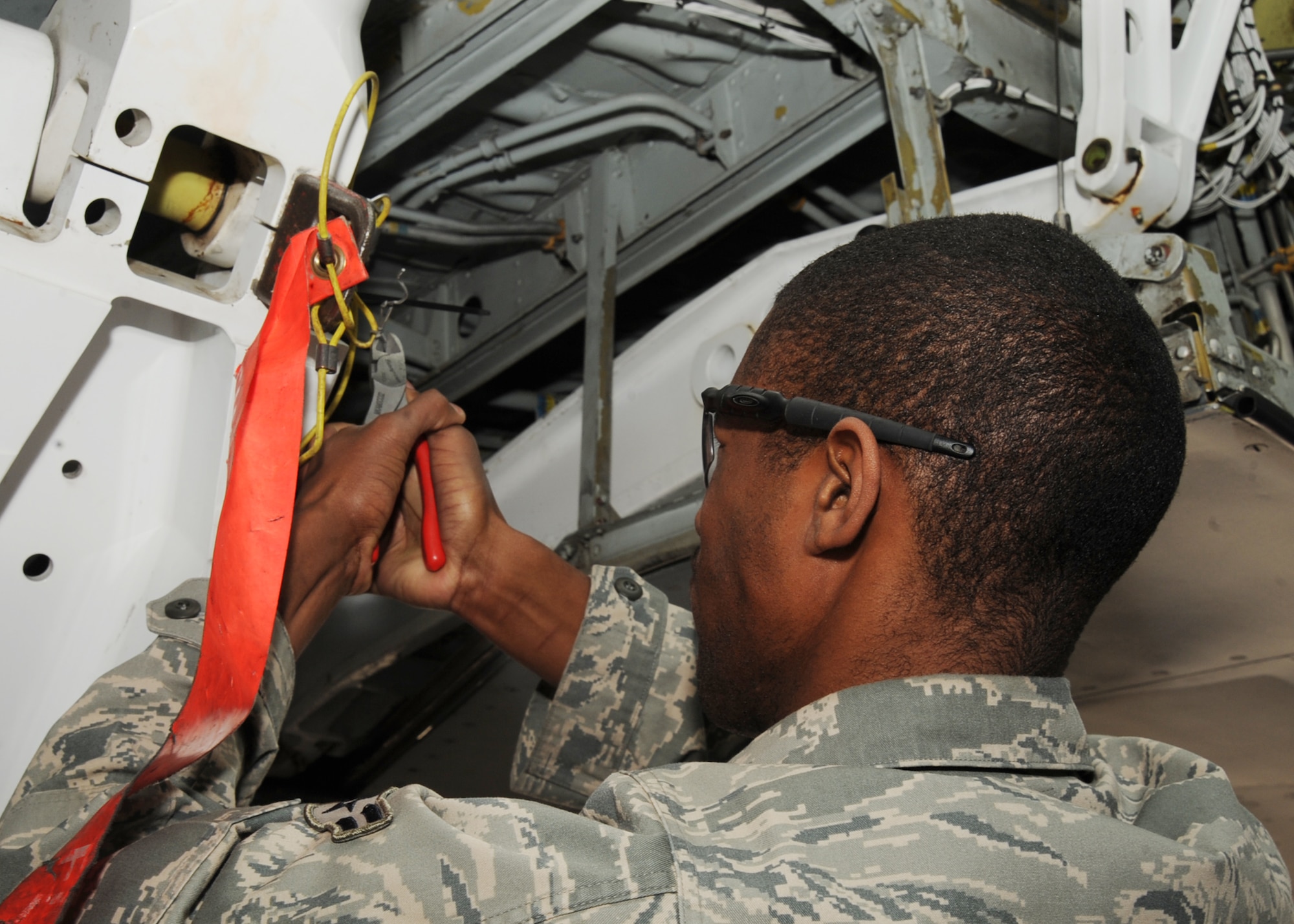 Airman 1st Class Carlton Creary, 22nd Aircraft Maintenance Squadron crewchief, removes a broken pin from the main landing gear of a KC-135 Stratotanker during a preflight inspection March 29, 2010, McConnell Air Force Base, Kan. McConnell’s KC-135 Stratotankers were inspected for readiness during a Nuclear Operational Readiness Exercise. (U.S. Air Force photo/Senior Airman Maria Ruiz)