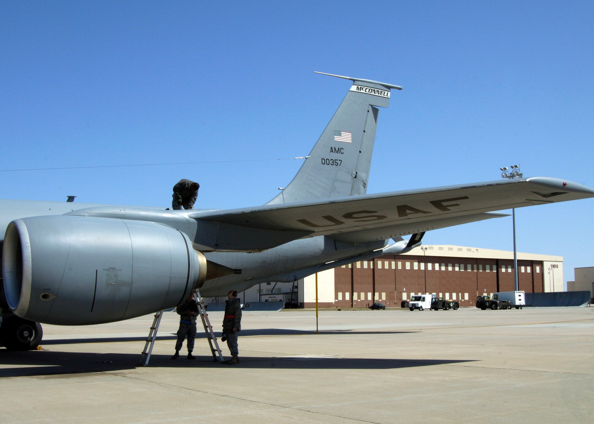 Airman Traivon McGee, 22nd Aircraft Maintenance Squadron crew chief, installs a bracket on a KC-135 Stratotanker engine inboard wrap around panel as Staff Sgt. Miguel Verdejo and Senior Airman Gage Stiltner, 22nd Maintenance Squadron aircraft structural maintenance, stand guard for safety during a Nuclear Operational Readiness Exercise March 29, 2010, McConnell Air Force Base, Kan. The NORE requires constantly preparing KC-135s for a sudden emergency flight takeoff. (U.S. Air Force photo/Airman 1st Class Andrea Salazar)