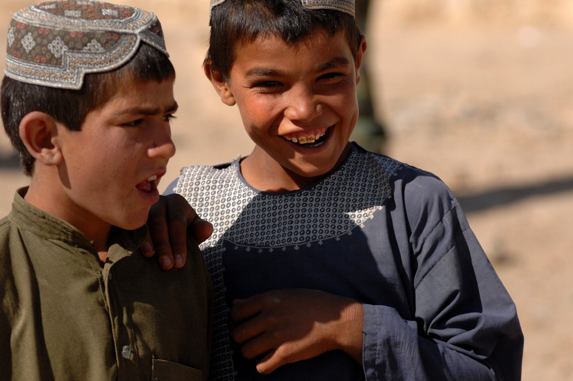 A young Afghan boy smiles for the camera as U.S. and Afghan National Army soldiers visit his village to deliver school supplies and conduct counterinsurgency operations, March 31, 2010, Morgan Kacha village, Southern Afghanistan. School supplies were handed out by ANA soldiers, while troop leaders talked with the village elders. (U.S. Air Force photo by Senior Airman Kenny Holston) 
