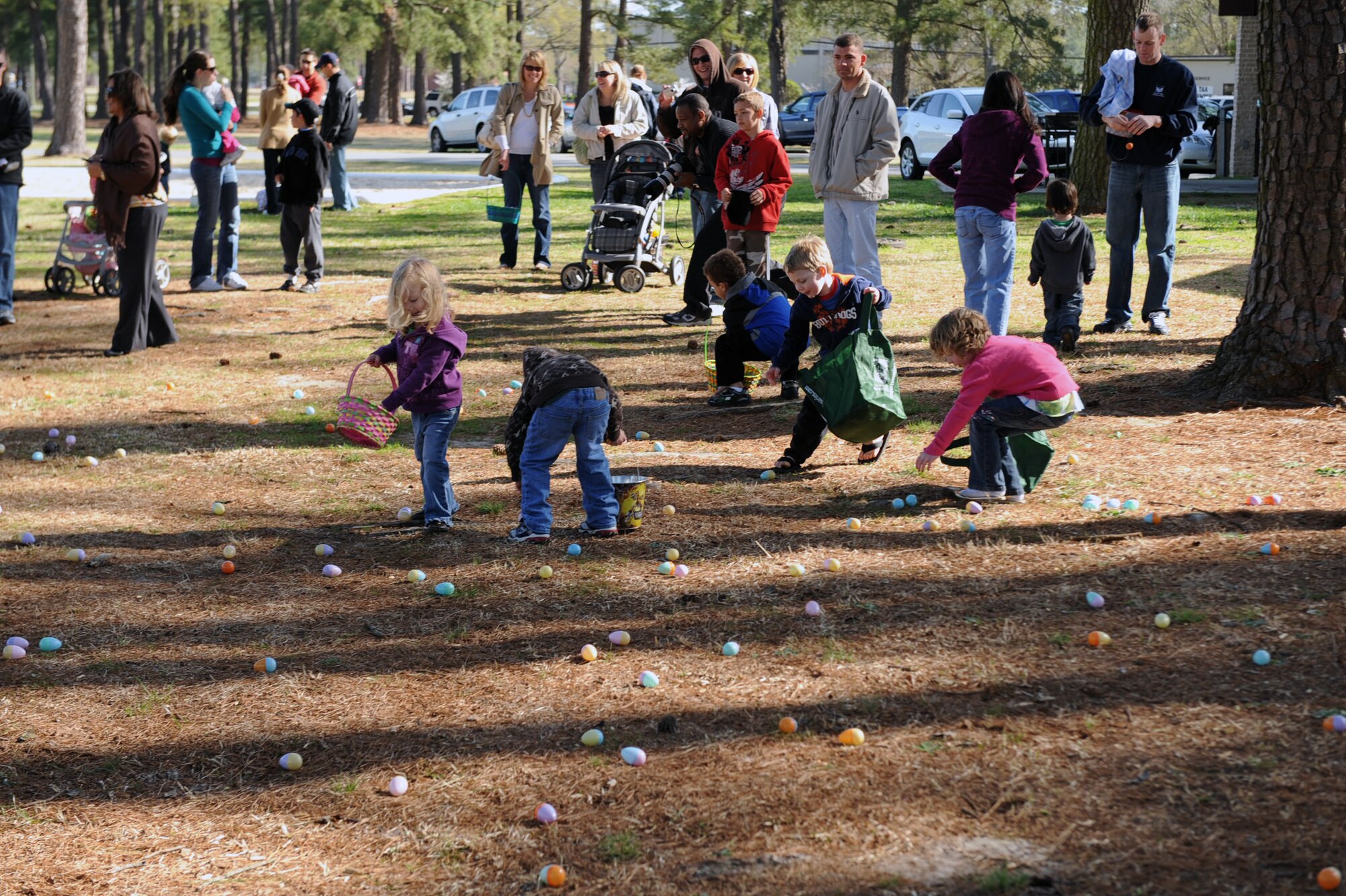 Base youth race to collect Easter eggs at Debden Park on Seymour Johnson Air Force Base, N.C., March 27, 2010. The Easter egg hunt is one of many base events sponsored by the Airman & Family Readiness Center as part of the DePLAYment tag pass program. The DePLAYment program offers family members of deployed Airmen free or discounted entry into events on and off base. (U.S. Air Force photo/Senior Airman Ciara Wymbs) 
