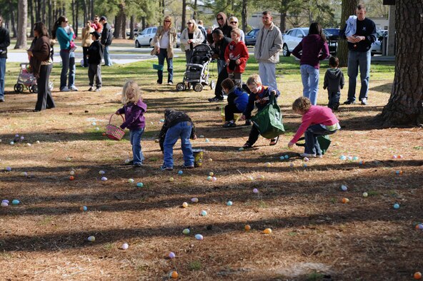 Base youth race to collect Easter eggs at Debden Park on Seymour Johnson Air Force Base, N.C., March 27, 2010. The Easter egg hunt is one of many base events sponsored by the Airman & Family Readiness Center as part of the DePLAYment tag pass program. The DePLAYment program offers family members of deployed Airmen free or discounted entry into events on and off base. (U.S. Air Force photo/Senior Airman Ciara Wymbs) 