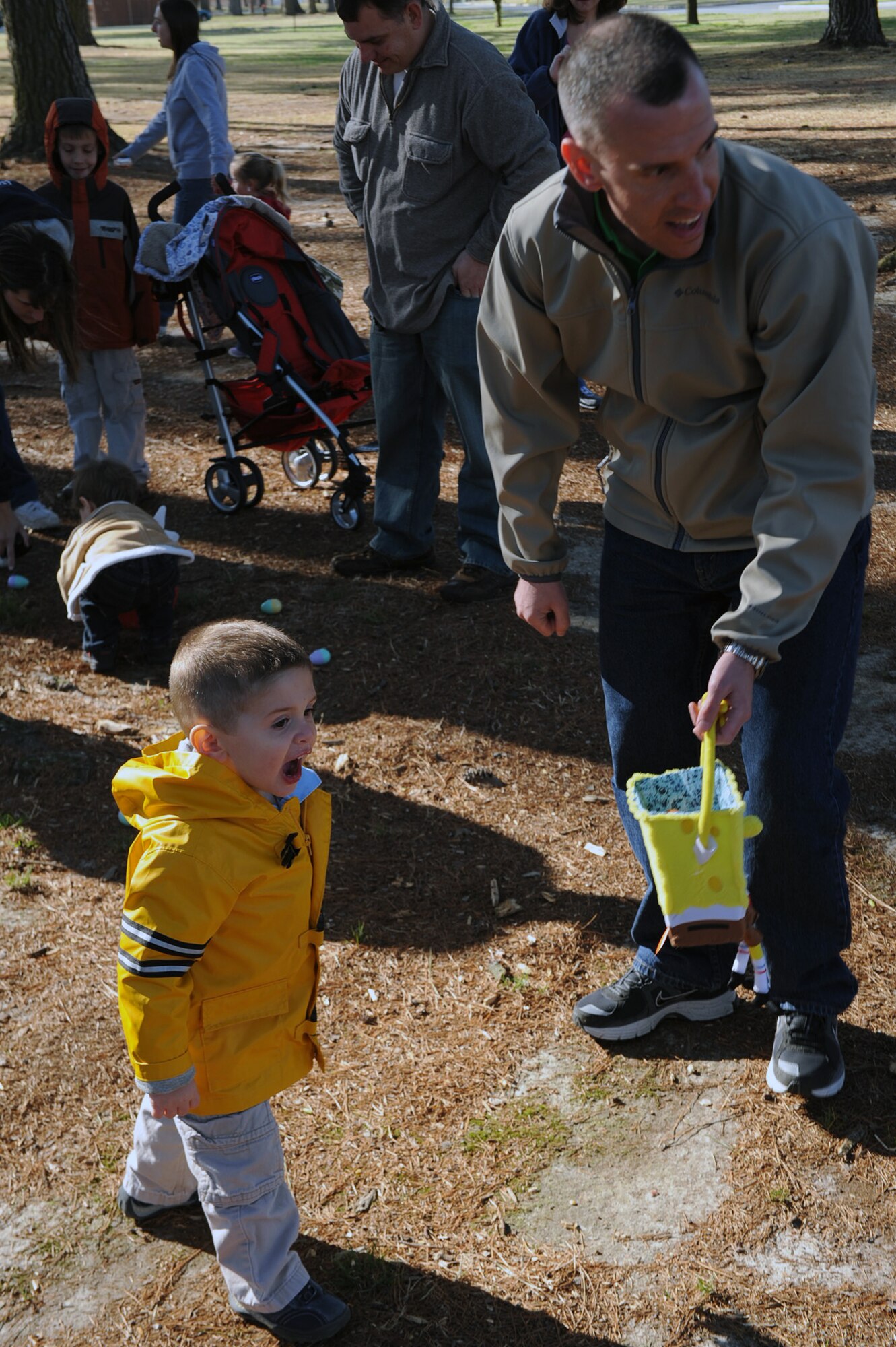 Capt. Joshua Connell, 4th Civil Engineer Squadron Explosive Ordnance Disposal flight commander, helps his son Andrew, 2, find eggs at Debden Park during the base Easter egg hunt on Seymour Johnson Air Force Base, N.C., March 27, 2010. The event also featured a cakewalk where winners won a homemade cake. (U.S. Air Force photo/Senior Airman Ciara Wymbs) 