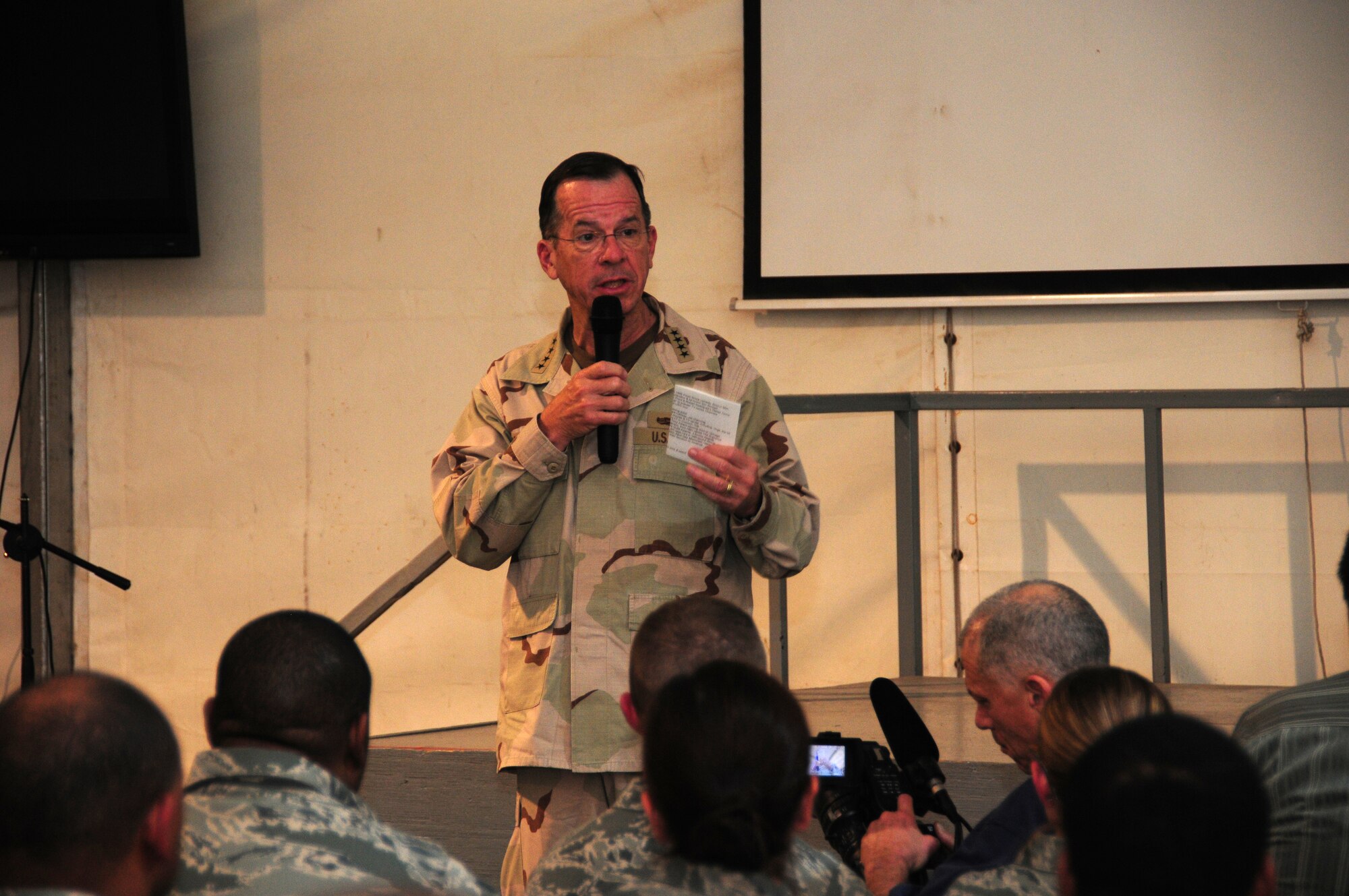 SOUTHWEST ASIA -- U.S. Navy Admiral Mike Mullen, chairman of the Joint Chiefs of Staff speaks to servicemembers, Department of Defense civilians and contract professionals during a USO tour March 31, 2010 at an undisclosed air base in Southwest Asia. Accompanying Admiral Mullen on a USO tour of the region were celebrities Rose McGowan from the WB Television Network series "Charmed", James Gandolfini and Tony Sirico from the HBO series "The Sopranos", and New Orleans Saints offensive tackle Jon Stinchcomb.  (U.S. Air Force photo by Staff Sgt. Lakisha A. Croley/Released)