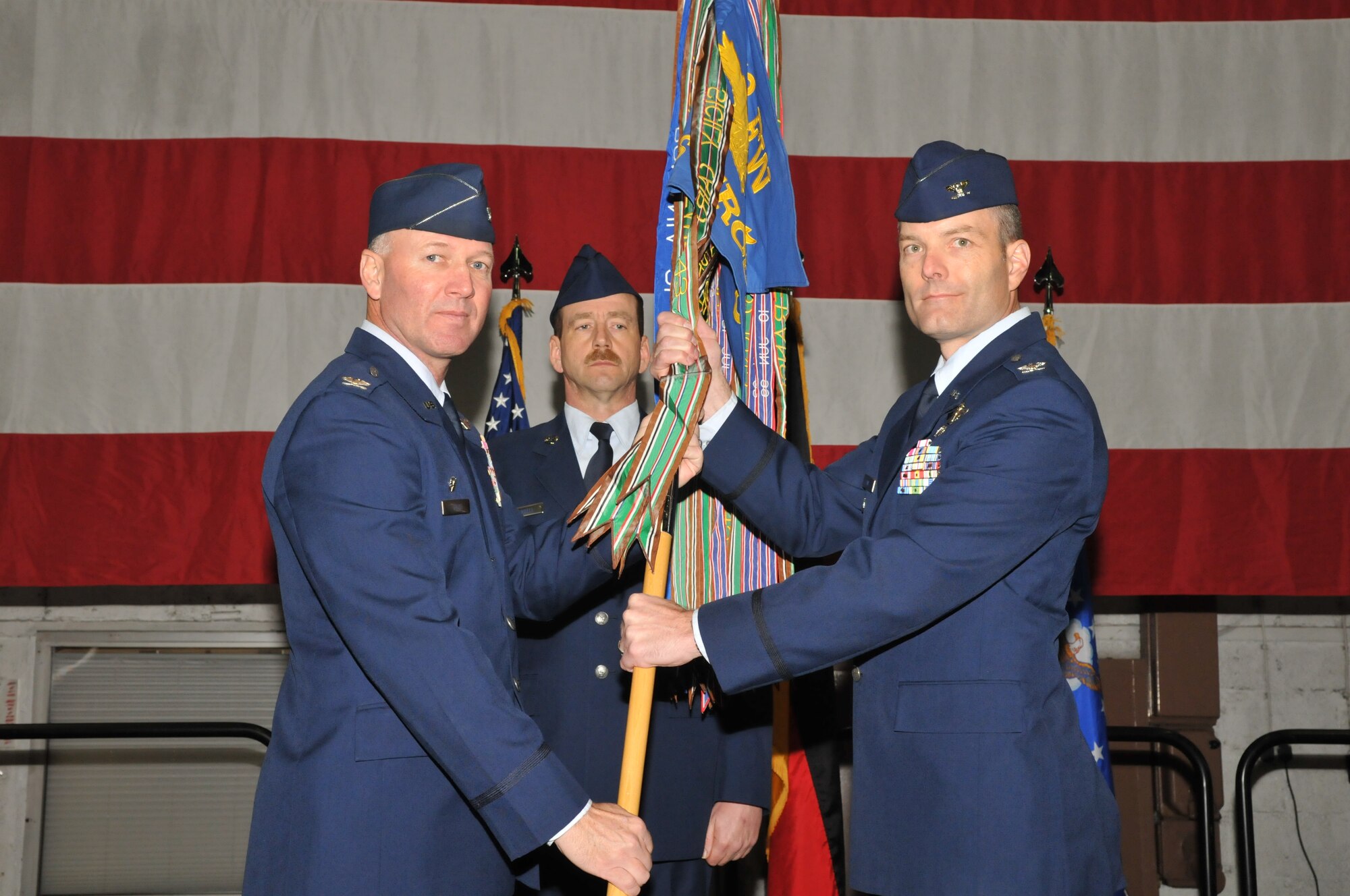 SPANGDAHLEM AIR BASE, Germany – Col. Tip Wight, 52nd Fighter Wing commander, passes the guidon to Col. Jackson Fox, 52nd Operations Group commander, during the 52nd OG change of command March 26. Colonel Fox took command of the 52nd OG from Col. Patrick McCrea. (U.S. Air Force photo/Airman 1st Class Nick Wilson)