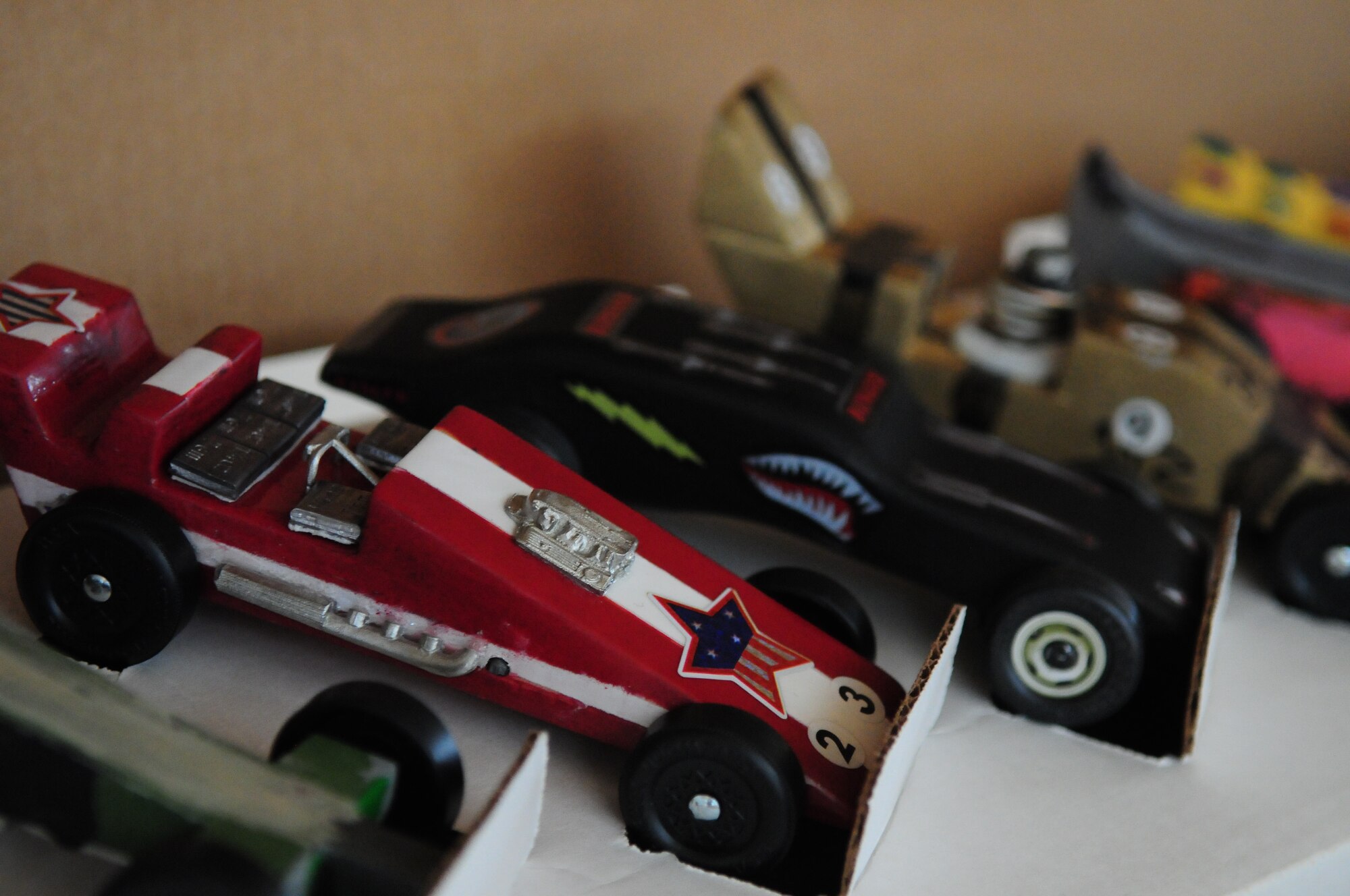 BITBURG ANNEX, Germany -- Various pinewood derby cars sit on display March 27.  Various dens from Boy Scout pack 161 competed for the annual Pinewood Derby title. (U.S. Air Force photo/Staff Sgt. Heather M. Norris)
