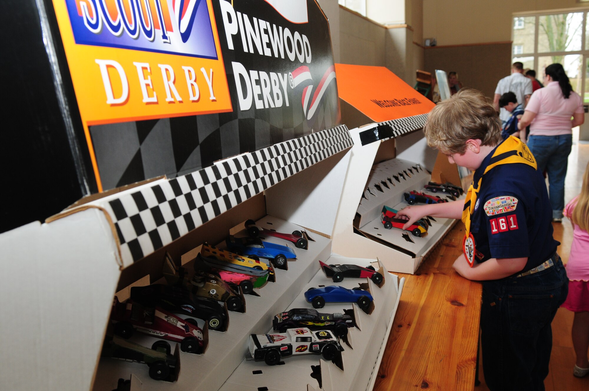 BITBURG ANNEX, Germany -- Samuel Davis, Wolf den, looks at the various pinewood derby cars on display March 27.  Each den from Boy Scout Pack 161 raced in four heats and each den winner competed against the other dens for the annual Pinewood Derby title. (U.S. Air Force photo/Staff Sgt. Heather M. Norris)