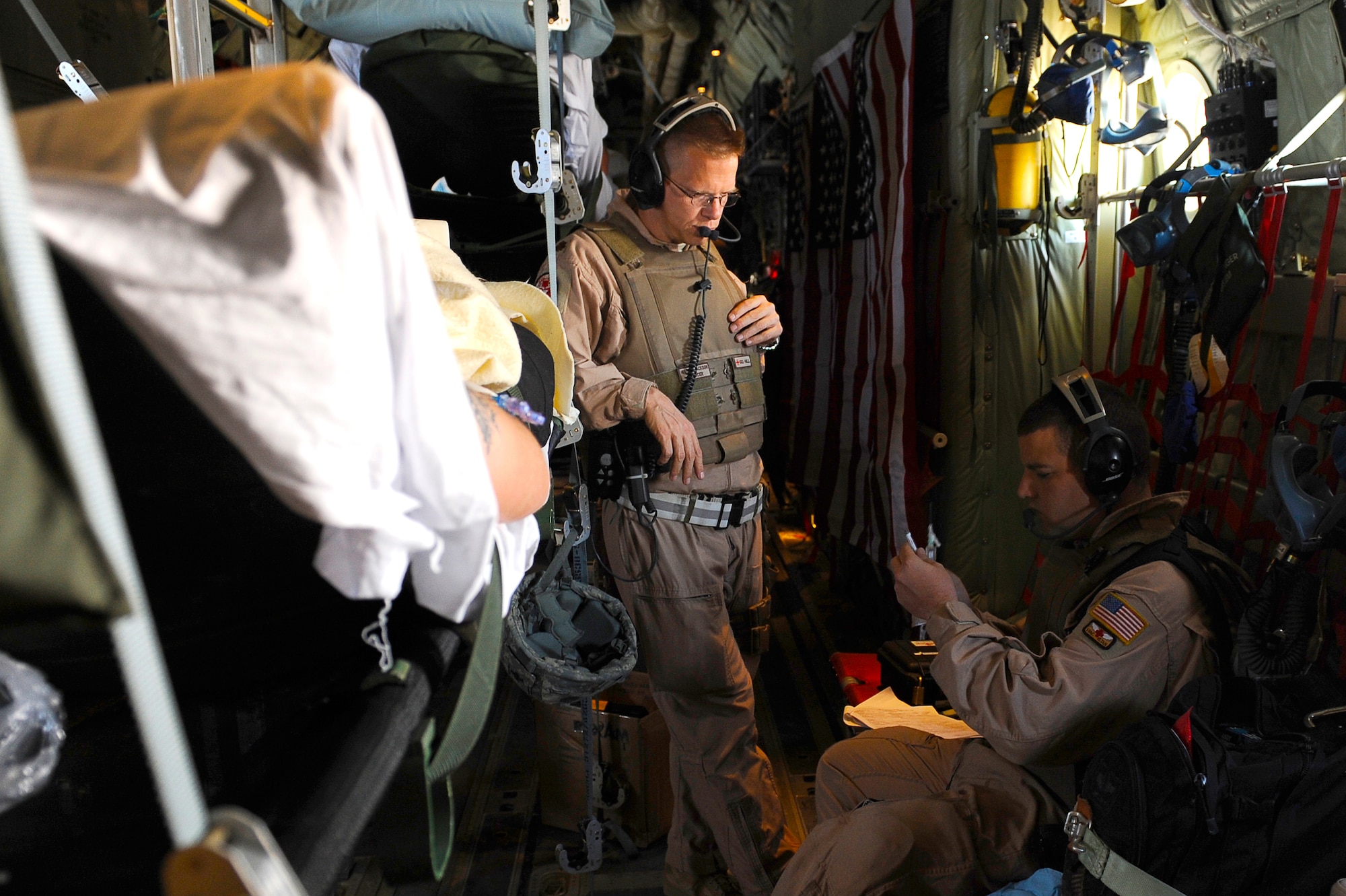 U.S. Air Force Maj. Richard Foote (left) and Tech. Sgt. Chris Hines, 455th Expeditionary Aeromedical Evacuation Flight,, prepare medication for a wounded U.S. servicemember in a C-130 over Afghanistan, March 26, 2010. The 774th Expeditionary Airlift Squadron in Bagram flies C-130 aeromedical evacuations across Afghanistan. Major Foote is deployed from Maxell Air Force Base, Ala., and is from Mobile, Ala. Sergeant Hines is deployed from Maxwell AFB, Ala., and is from McClellan, Fla. (U.S. Air Force photo by/ Tech. Sgt. Jeromy K. Cross/released)
