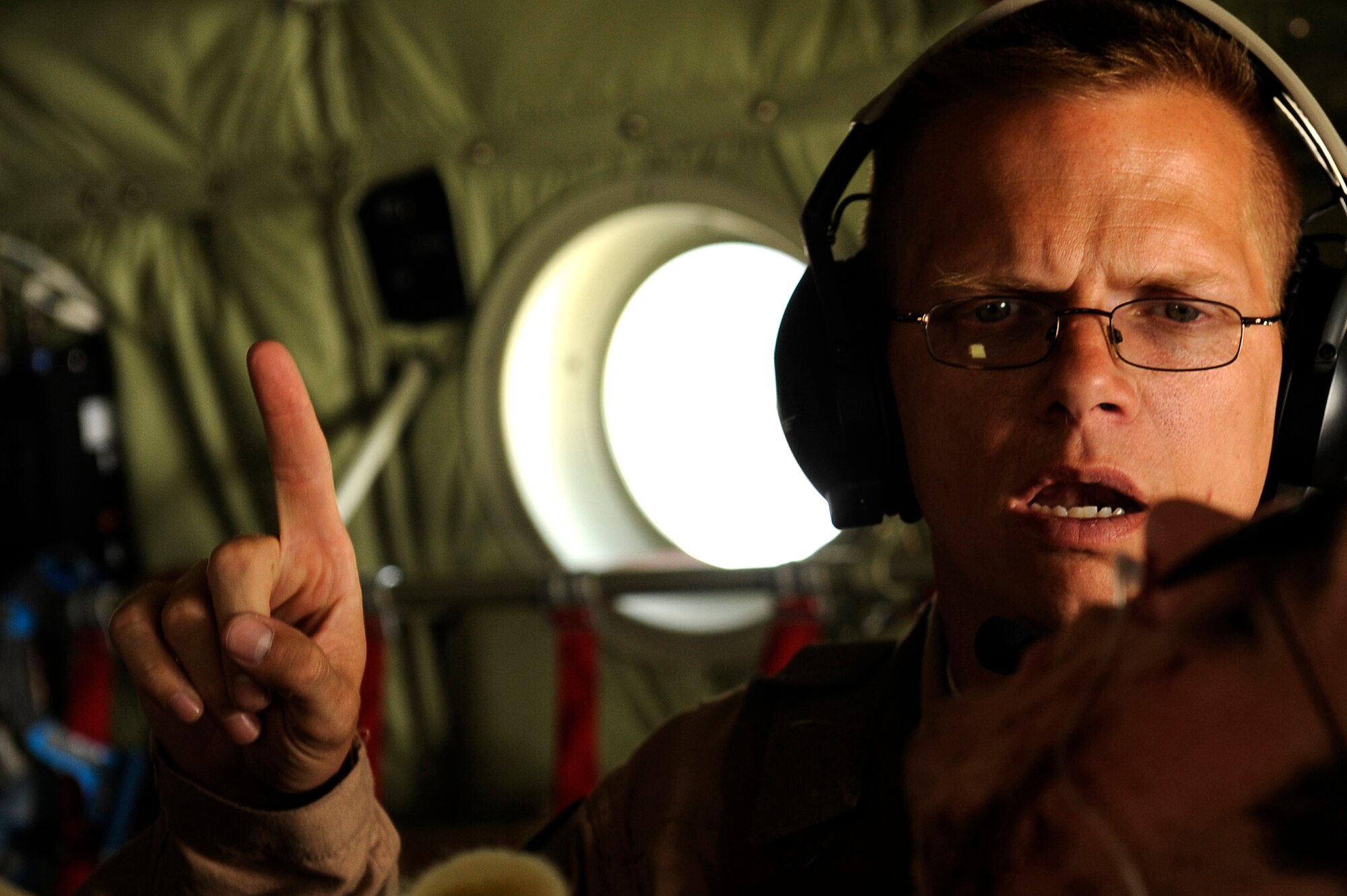 U.S. Air Force Maj. Richard Foote, 455th Expeditionary Aeromedical Evacuation Flight, checks on the condition of a wounded U.S. servicemember in a C-130 over Afghanistan, March 26, 2010. The 774th Expeditionary Airlift Squadron in Bagram flies C-130 aeromedical evacuations across Afghanistan. Major Foote is deployed from Maxell Air Force Base, Ala., and is from Mobile, Ala. (U.S. Air Force photo by/ Tech. Sgt. Jeromy K. Cross/released)