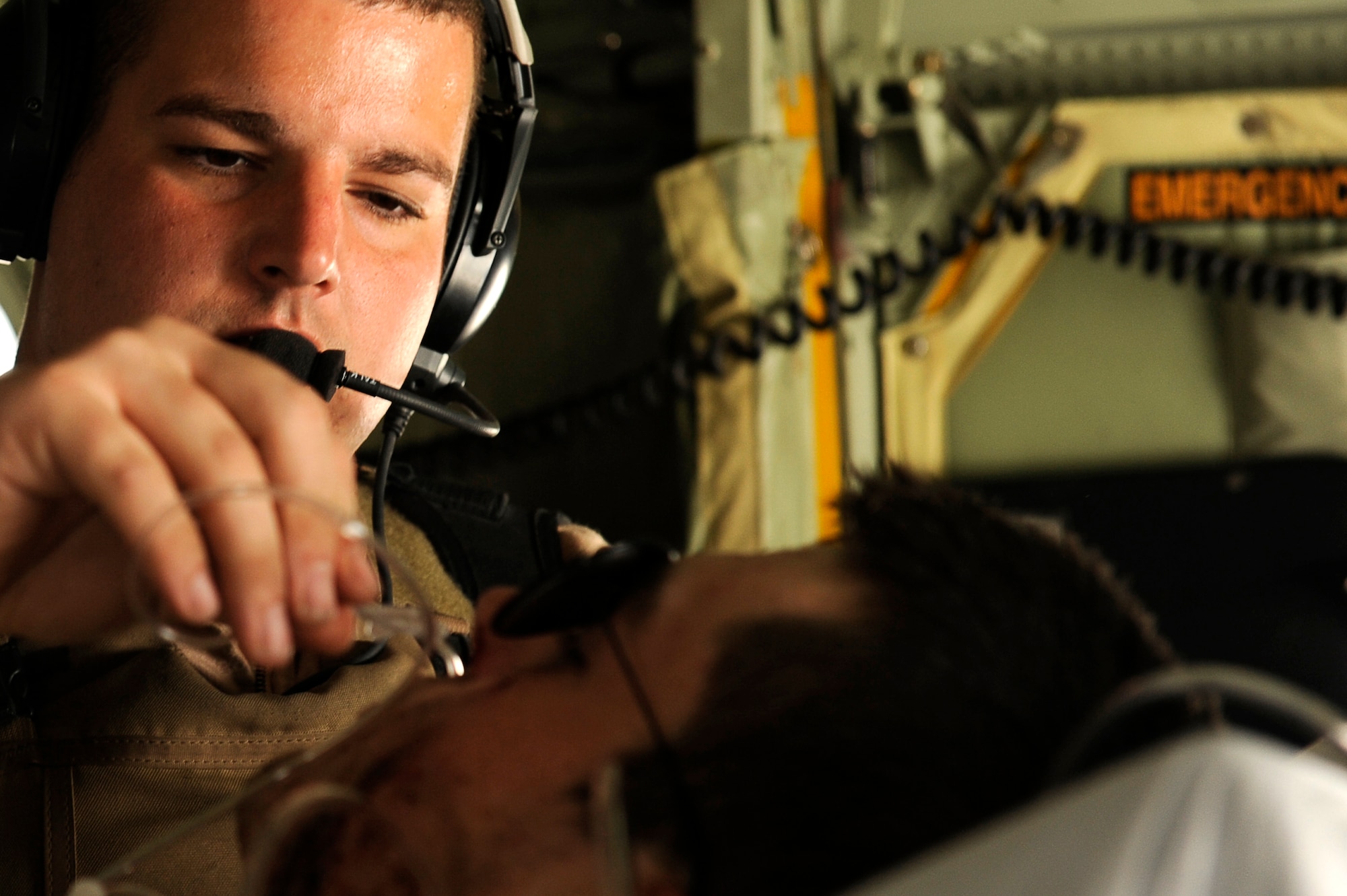 U.S. Air Force Tech. Sgt. Chris Hines, 455th Expeditionary Aeromedical Evacuation Flight, sets up an oxygen system for a wounded U.S. servicemember in a C-130 over Afghanistan, March 26, 2010. The 774th Expeditionary Airlift Squadron in Bagram flies C-130 aeromedical evacuations across Afghanistan. Sergeant Hines is deployed from Maxwell Air Force Base, Ala., and is from McClellan, Fla. (U.S. Air Force photo by/ Tech. Sgt. Jeromy K. Cross/released)