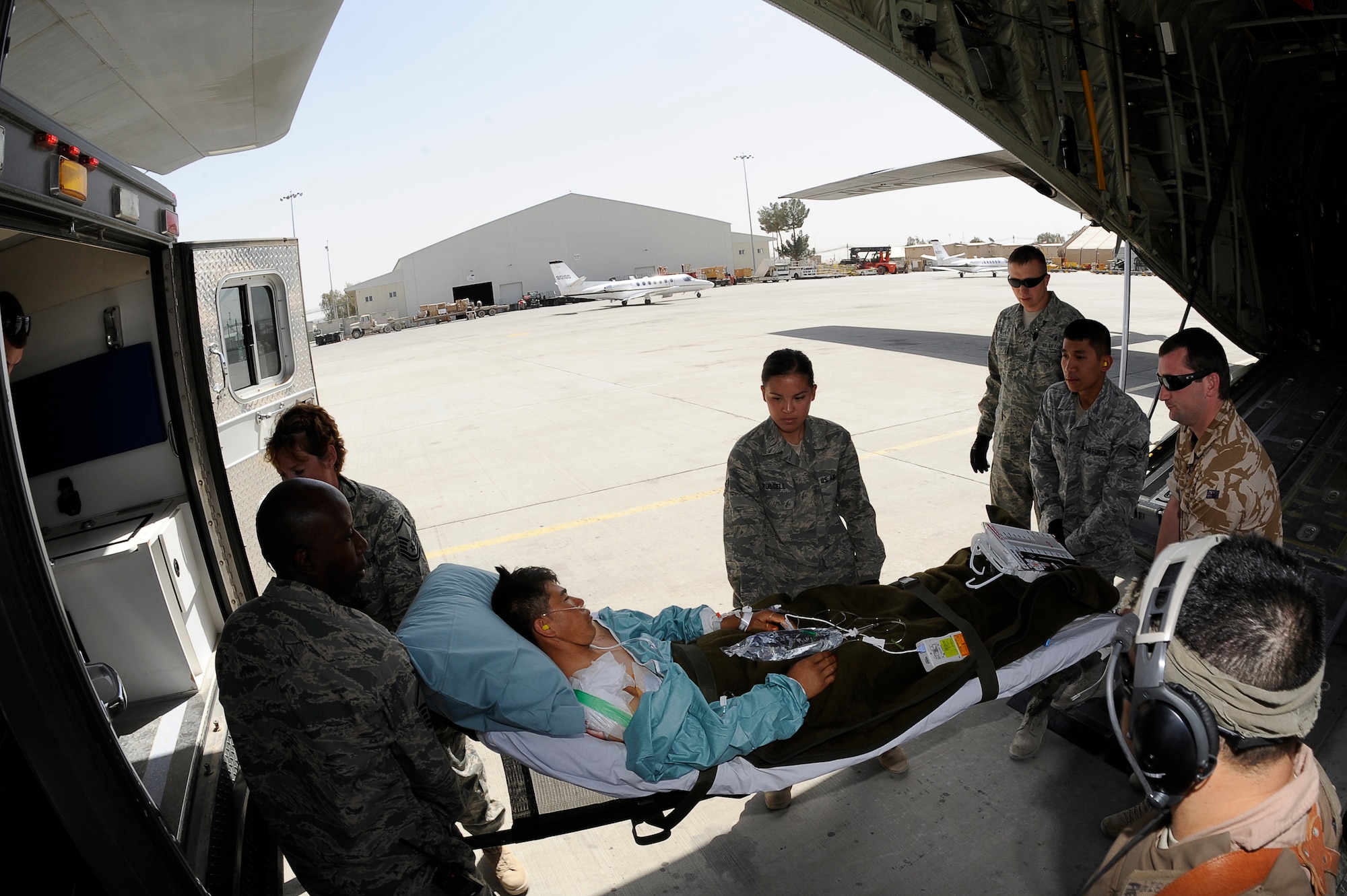 NATO forces move a wounded Afghan National Army soldier to an ambulance at Kandahar Airfield, Afghanistan, March 26, 2010. The 774th Expeditionary Airlift Squadron in Bagram flies C-130 aeromedical evacuations across Afghanistan. (U.S. Air Force photo by/ Tech. Sgt. Jeromy K. Cross/released)





