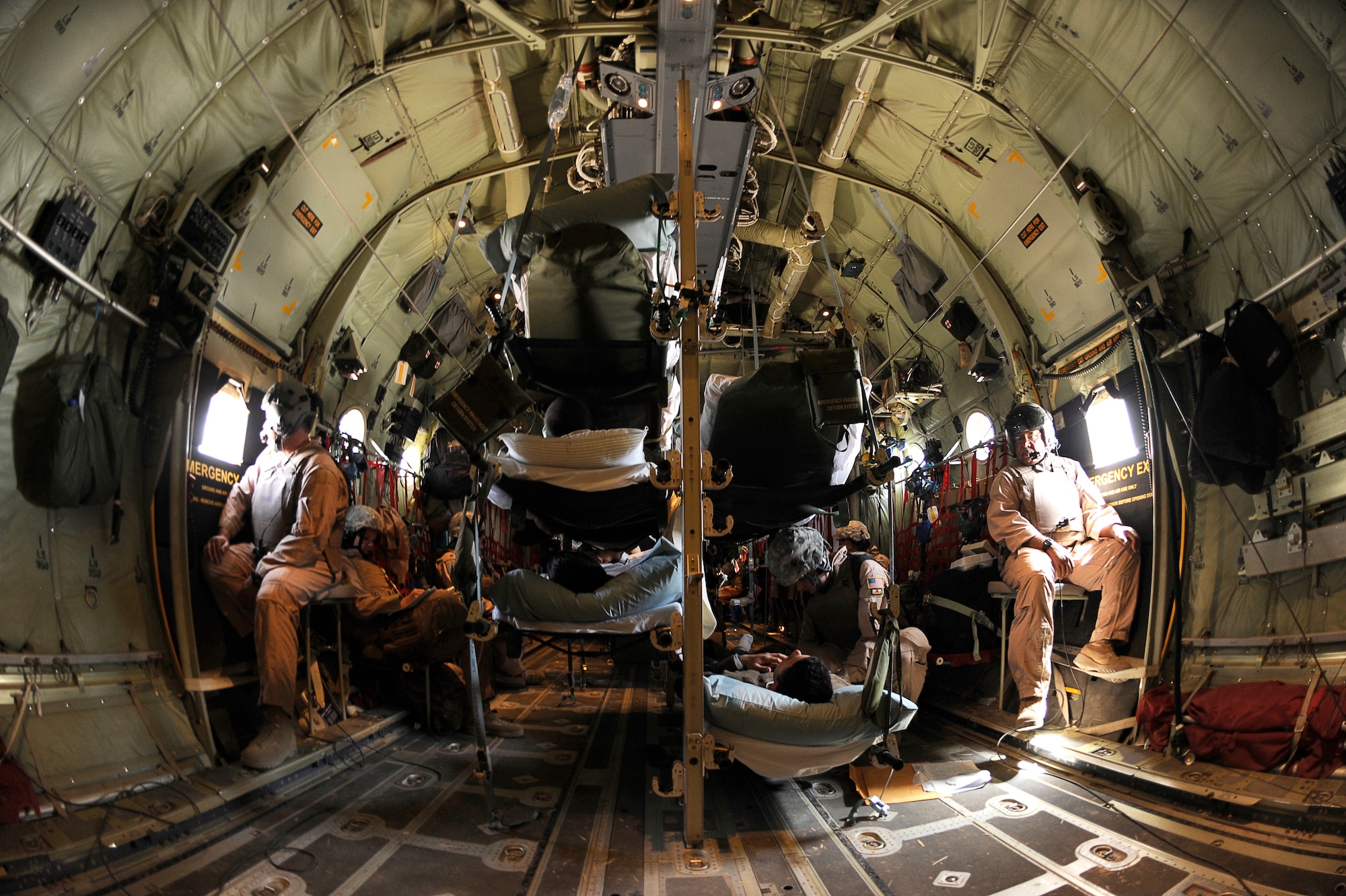 U.S. Air Force Airmen from the 455th Expeditionary Aeromedical Evacuation Flight,  transport wounded Afghan National Army soldiers and U.S. Military personnel during a medical evacuation in a C-130 over Afghanistan, March 26, 2010. The 774th Expeditionary Airlift Squadron in Bagram flies C-130 aeromedical evacuations across Afghanistan. (U.S. Air Force photo by/ Tech. Sgt. Jeromy K. Cross/released)