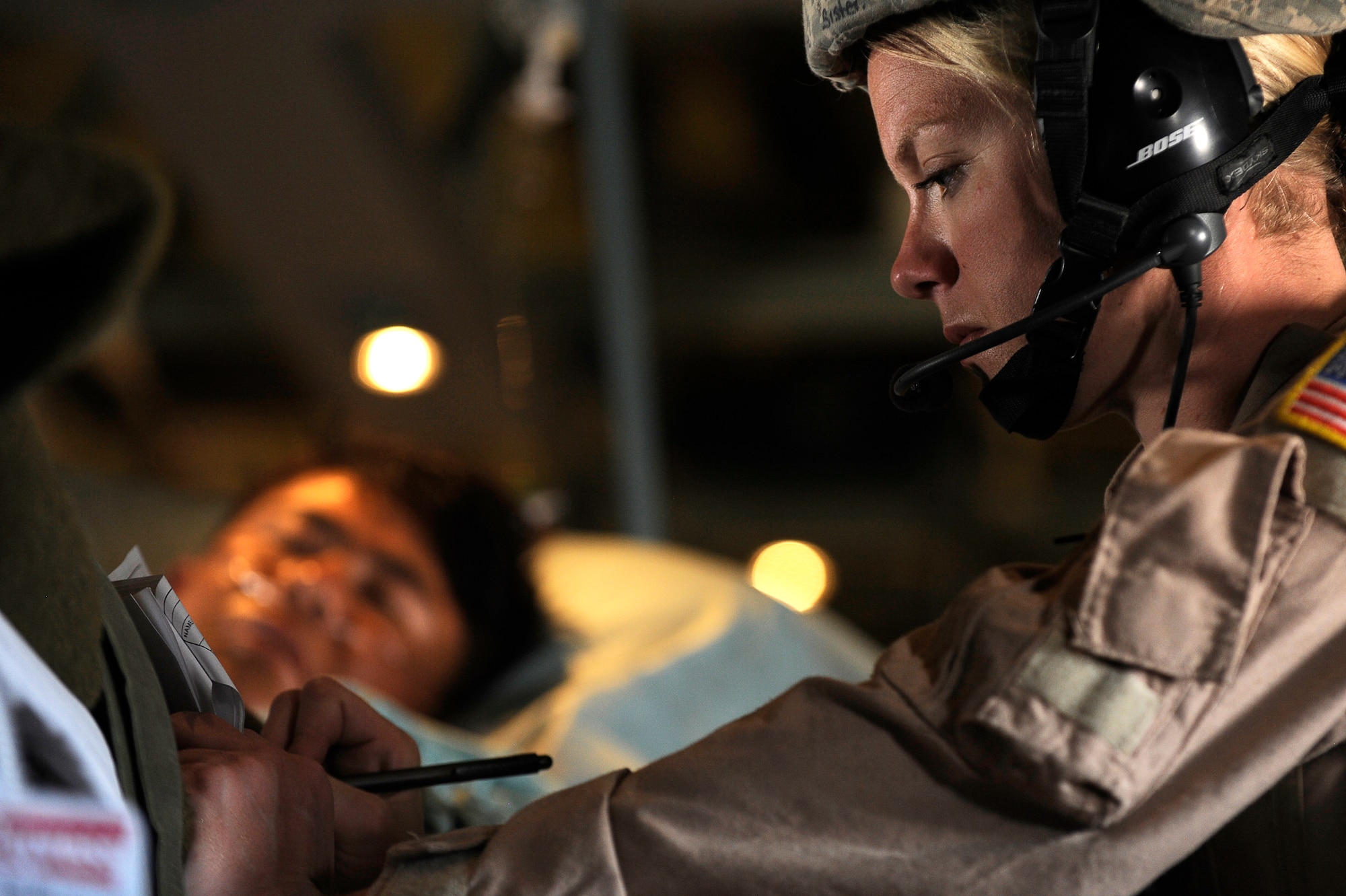 U.S. Air Force Tech. Sgt. Kim Price, 455th Expeditionary Aeromedical Evacuation Flight, checks on the condition of a wounded Afghan National Army soldier during a medical evacuation in a C-130 over Afghanistan, March 26, 2010. The 774th Expeditionary Airlift Squadron in Bagram flies C-130 aeromedical evacuations across Afghanistan. Sergeant Price is deployed from Maxwell Air Force Base, Ala., and is from Pittsburgh, Pa. (U.S. Air Force photo by/ Tech. Sgt. Jeromy K. Cross/released)