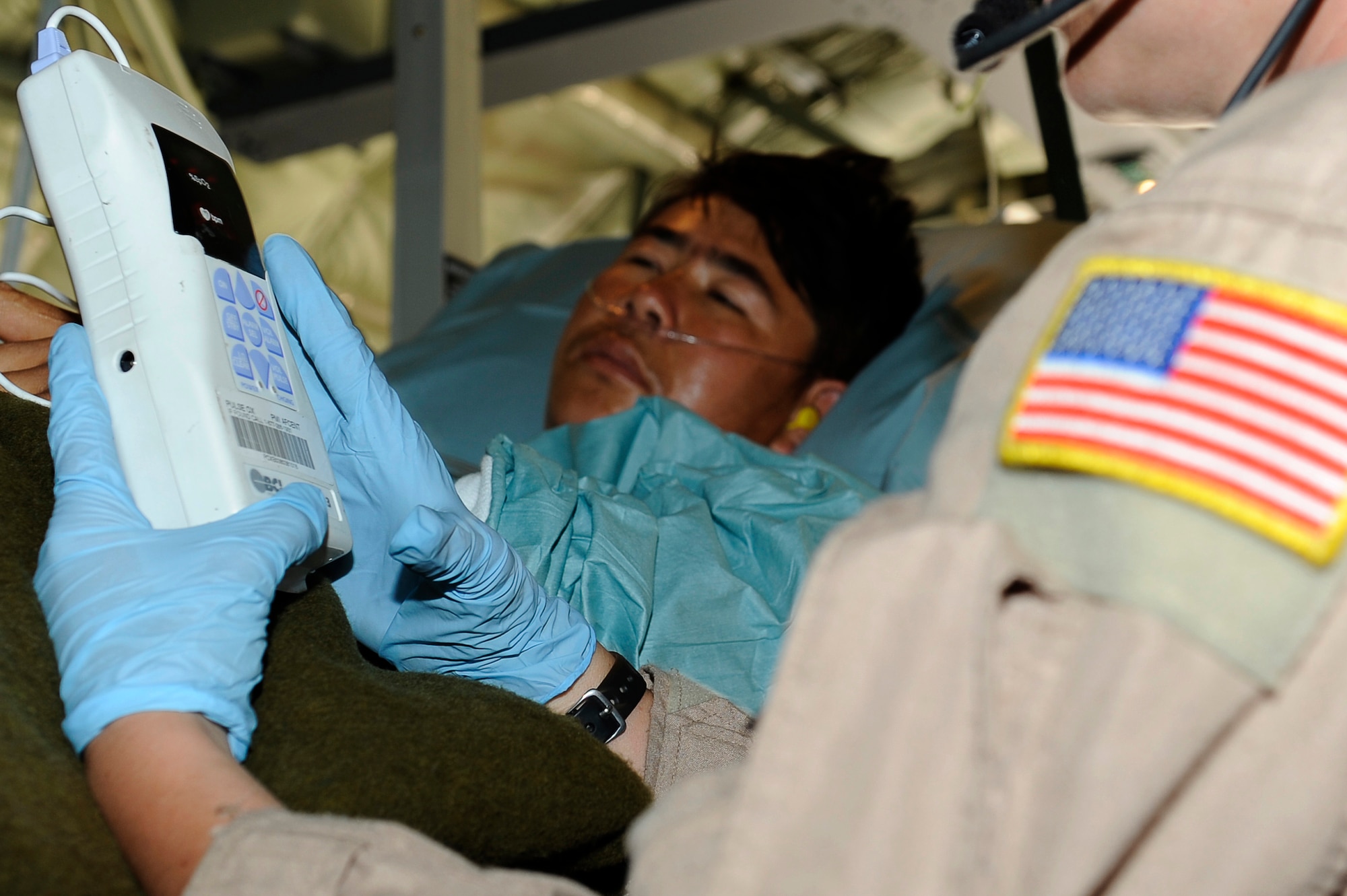 U.S. Air Force Tech. Sgt. Kim Price, 455th Expeditionary Aeromedical Evacuation Flight, checks on the condition of a wounded Afghan National Army soldier during a medical evacuation at Camp Bastion, Afghanistan, March 26, 2010. The 774th Expeditionary Airlift Squadron in Bagram flies C-130 aeromedical evacuations across Afghanistan. Sergeant Price is deployed from Maxwell Air Force Base, Ala., and is from Pittsburgh, Pa. (U.S. Air Force photo by/ Tech. Sgt. Jeromy K. Cross/released)