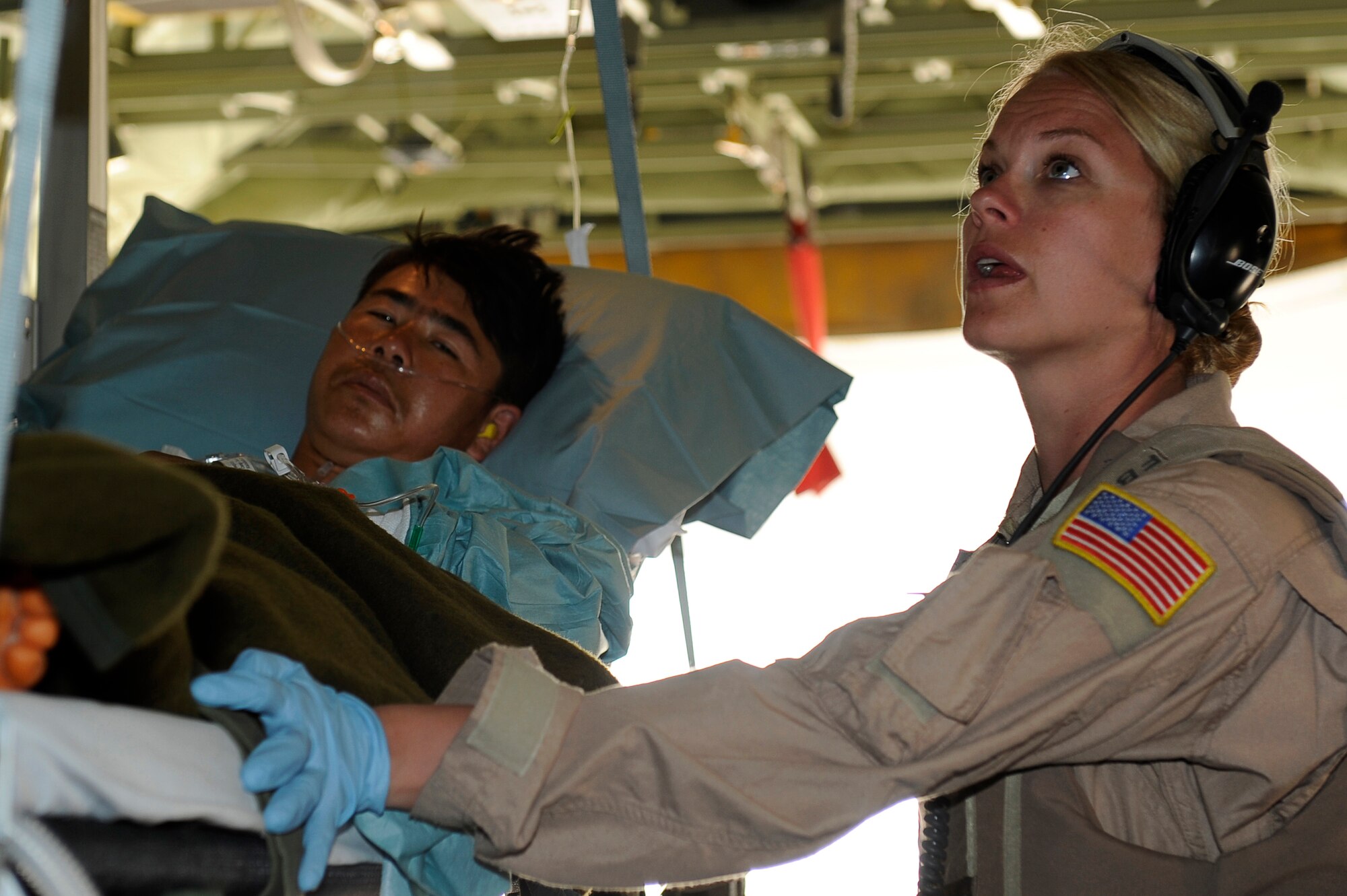 U.S. Air Force Tech. Sgt. Kim Price, 455th Expeditionary Aeromedical Evacuation Flight, checks on the condition of a wounded Afghan National Army soldier during a medical evacuation at Camp Bastion, Afghanistan, March 26, 2010. The 774th Expeditionary Airlift Squadron in Bagram flies C-130 aeromedical evacuations across Afghanistan. Sergeant Price is deployed from Maxwell Air Force Base, Ala., and is from Pittsburgh, Pa. (U.S. Air Force photo by/ Tech. Sgt. Jeromy K. Cross/released)