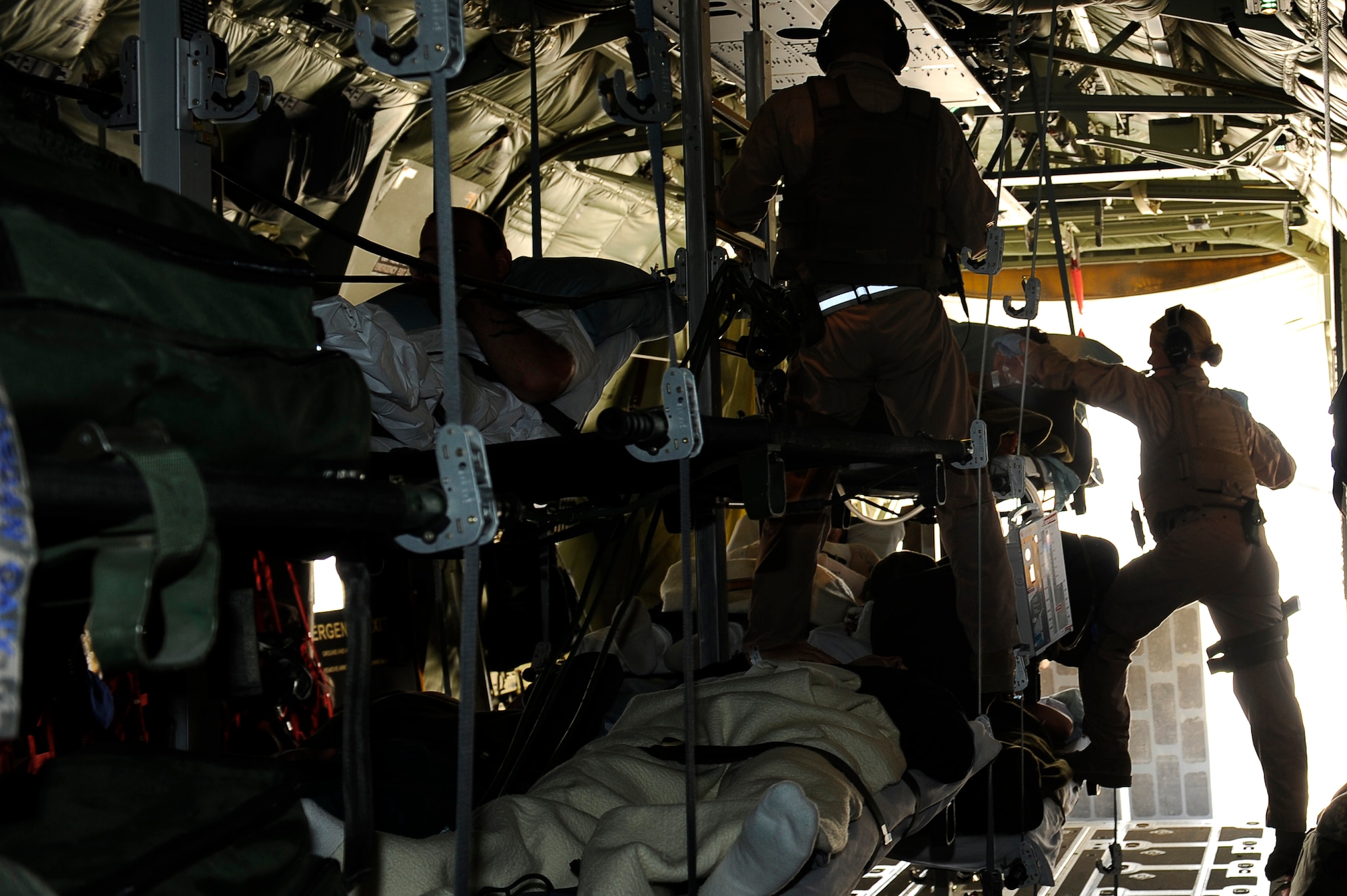 U.S. Air Force Airmen from the 455th Expeditionary Aeromedical Evacuation Flight,  secure wounded Afghan National Army soldiers for a medical evacuation in a C-130 at Camp Bastion, Afghanistan, March 26, 2010. The 774th Expeditionary Airlift Squadron in Bagram flies C-130 aeromedical evacuations across Afghanistan. (U.S. Air Force photo by/ Tech. Sgt. Jeromy K. Cross/released)
