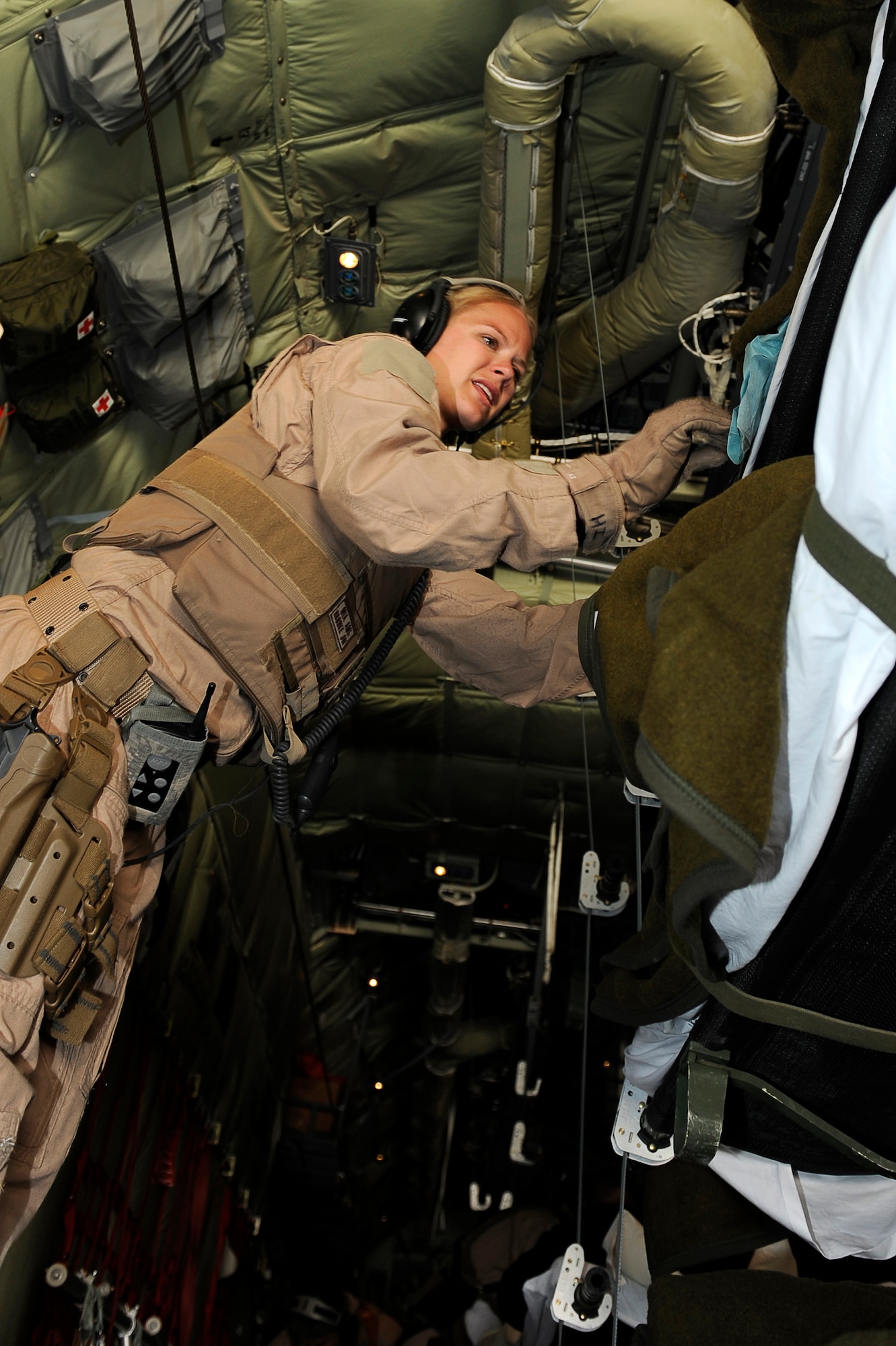 U.S. Air Force Tech. Sgt. Kim Price, 455th Expeditionary Aeromedical Evacuation Flight, checks on the condition of a wounded Afghan National Army soldier during a medical evacuation at Camp Bastion, Afghanistan, March 26, 2010. The 774th Expeditionary Airlift Squadron in Bagram flies C-130 aeromedical evacuations across Afghanistan. Sergeant Price is deployed from Maxwell Air Force Base, Ala., and is from Pittsburgh, Pa. (U.S. Air Force photo by/ Tech. Sgt. Jeromy K. Cross/released)