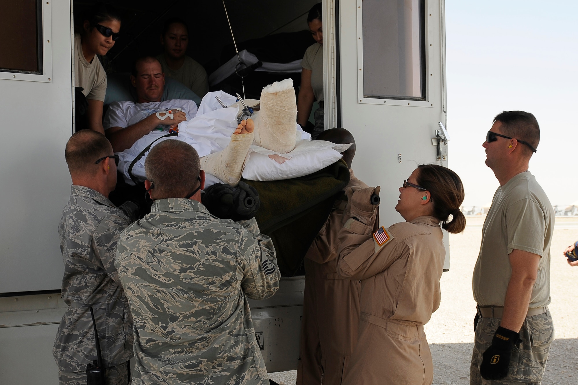 U.S. Air Force aeromedical Airmen take wounded personnel out of an ambulance and load them into a C-130 at Camp Bastion, Afghanistan, March 26, 2010. The 774th Expeditionary Airlift Squadron in Bagram flies C-130 aeromedical evacuations across Afghanistan. (U.S. Air Force photo by/ Tech. Sgt. Jeromy K. Cross/released)




