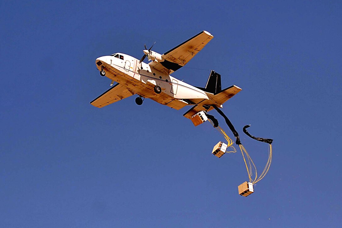 A contracted air plane drops humanitarian aide supplies for Aka Sadiq to U.S. Marines and  Afghan National Army soldiers at a drop site during a three-day combat reconnaissance patrol in the Bala Baluk District, Farah province, Afghanistan, March 30, 2010.