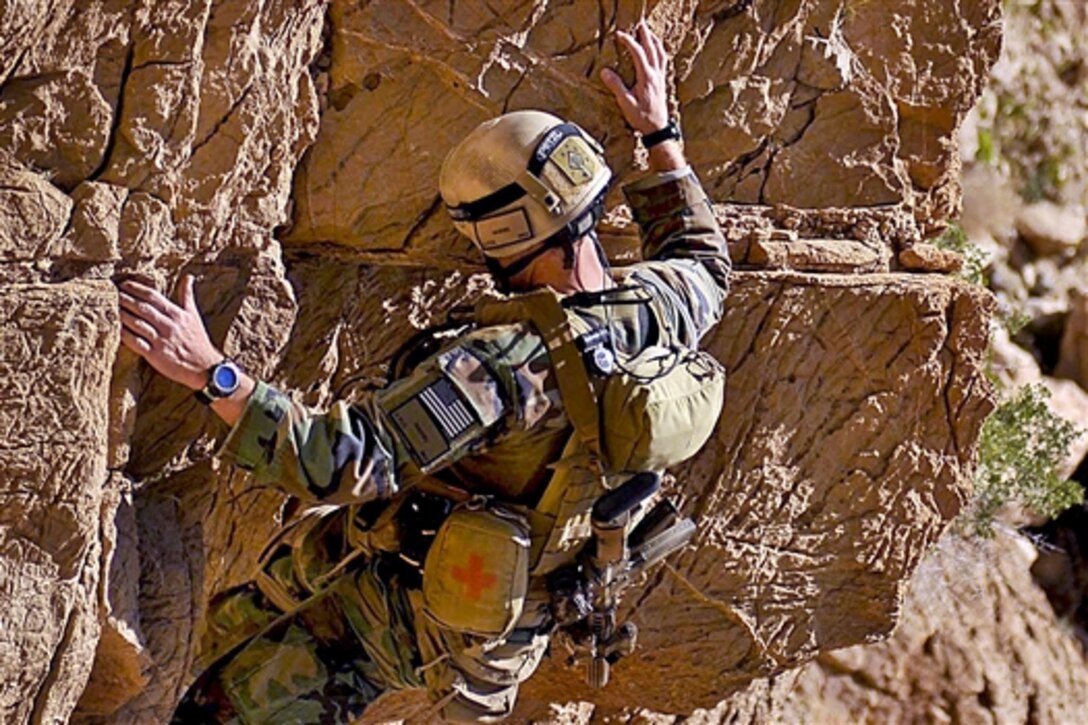 A U.S. Marine eases down the side of a mountain during a three-day combat reconnaissance patrol in the Bala Baluk district in Afghanistan's Farah province, March 31, 2010. The Marines are assigned to Marine Special Operation Command.